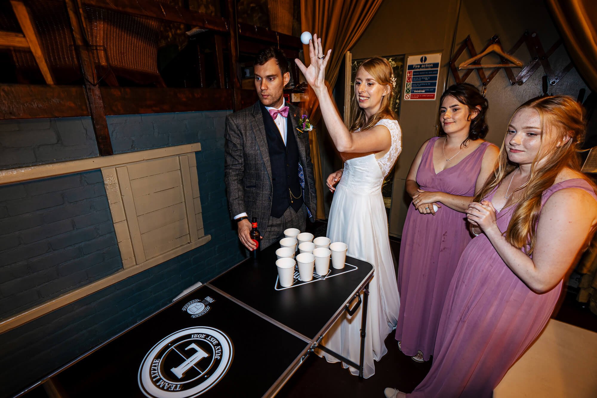 Bride playing beer pong in the evening