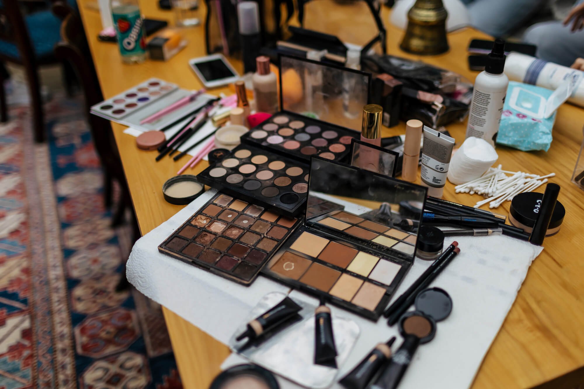 A table full of make up for the bride and bridesmaids