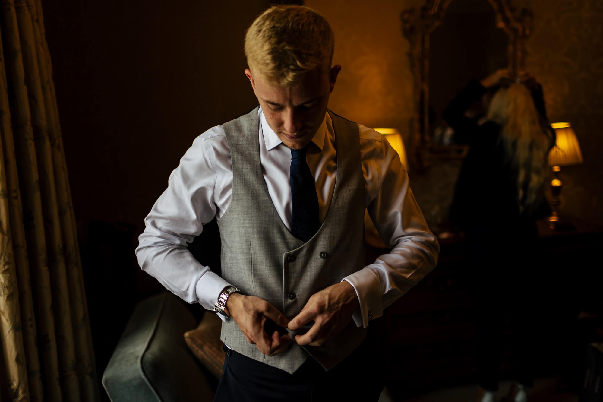 Groom getting dressed and ready for his wedding in Cumbria