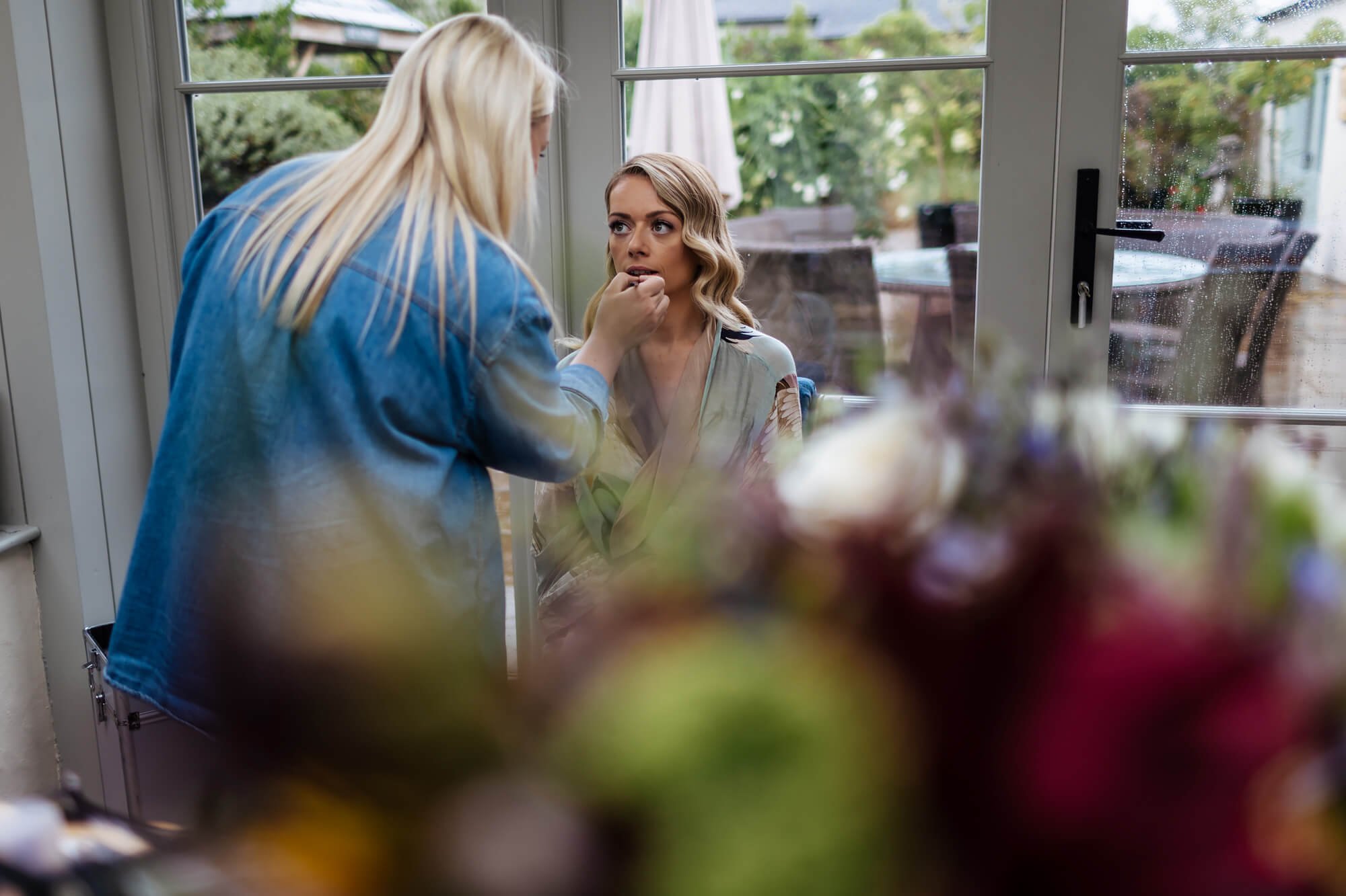 Bride has her make up applied before her wedding