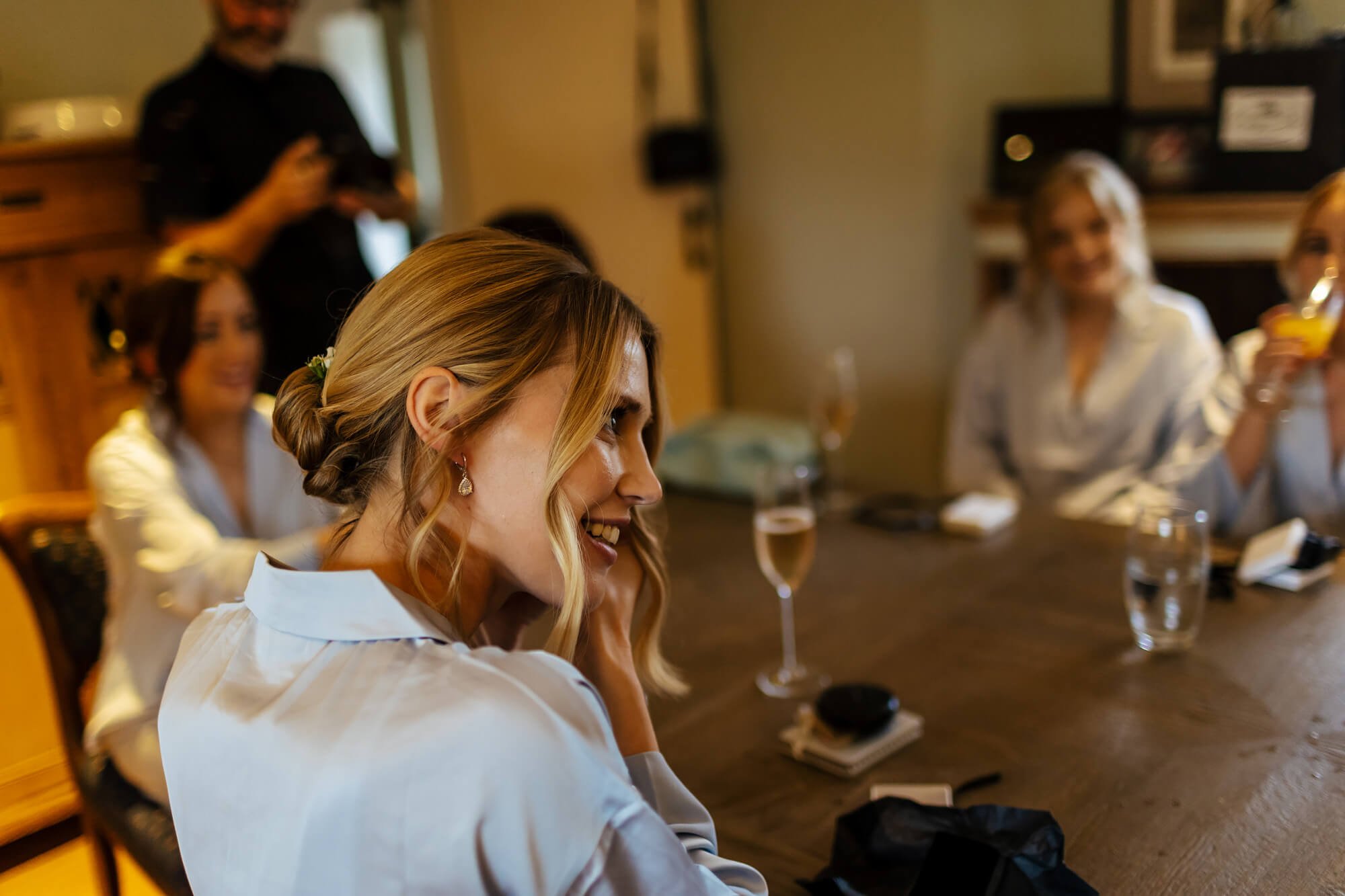 Bridesmaid trying on her earrings as a gift