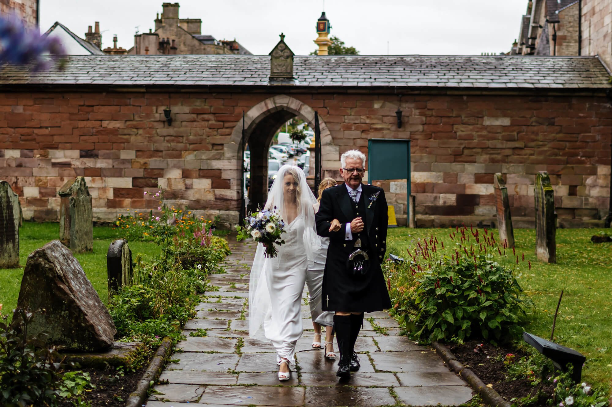 Bride and dad walking to the church in Cumbria