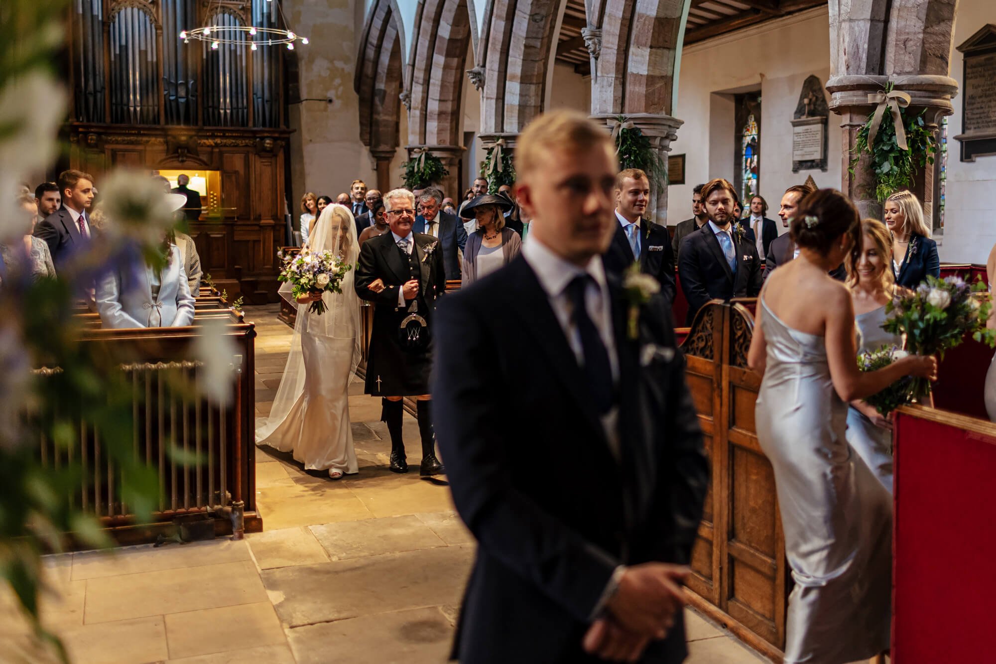 Bride walking down the aisle to meet the groom in the church