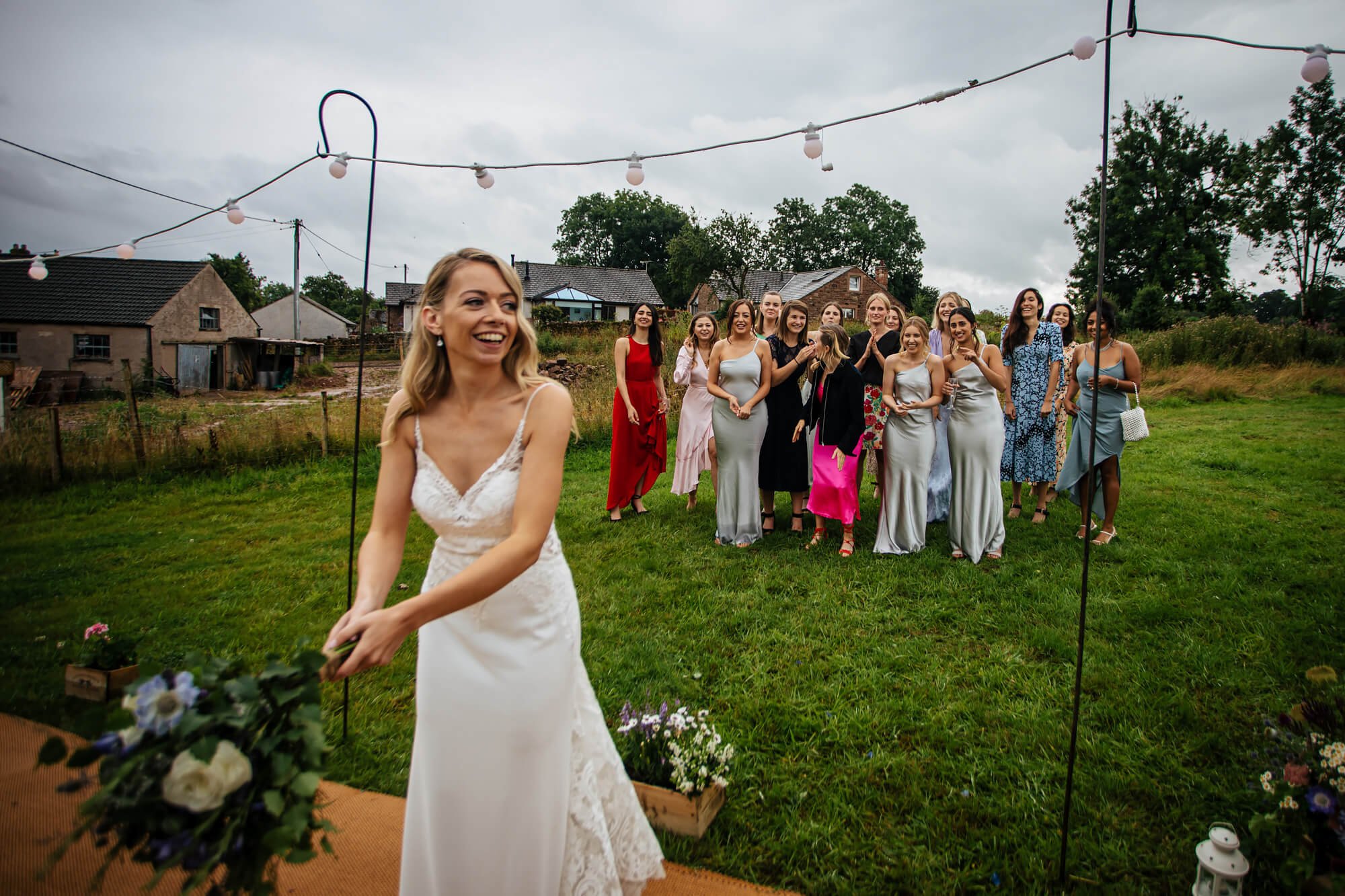 Bride throwing the bouquet to the girls in Cumbria