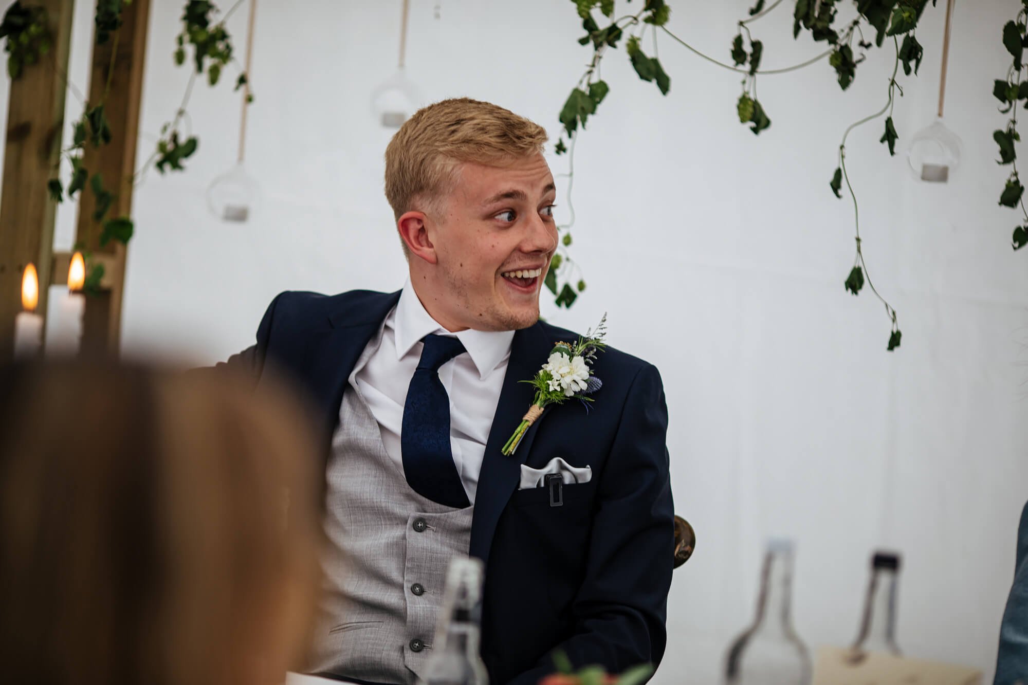 Groom looking surprised during a wedding speech