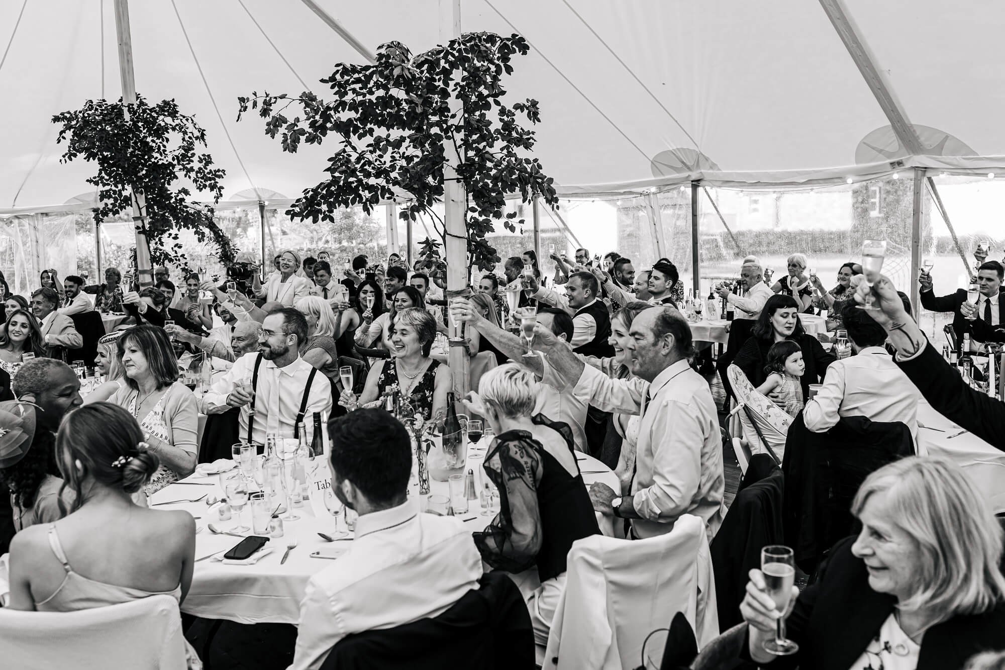 Guests toasting the wedding speeches in Cumbria