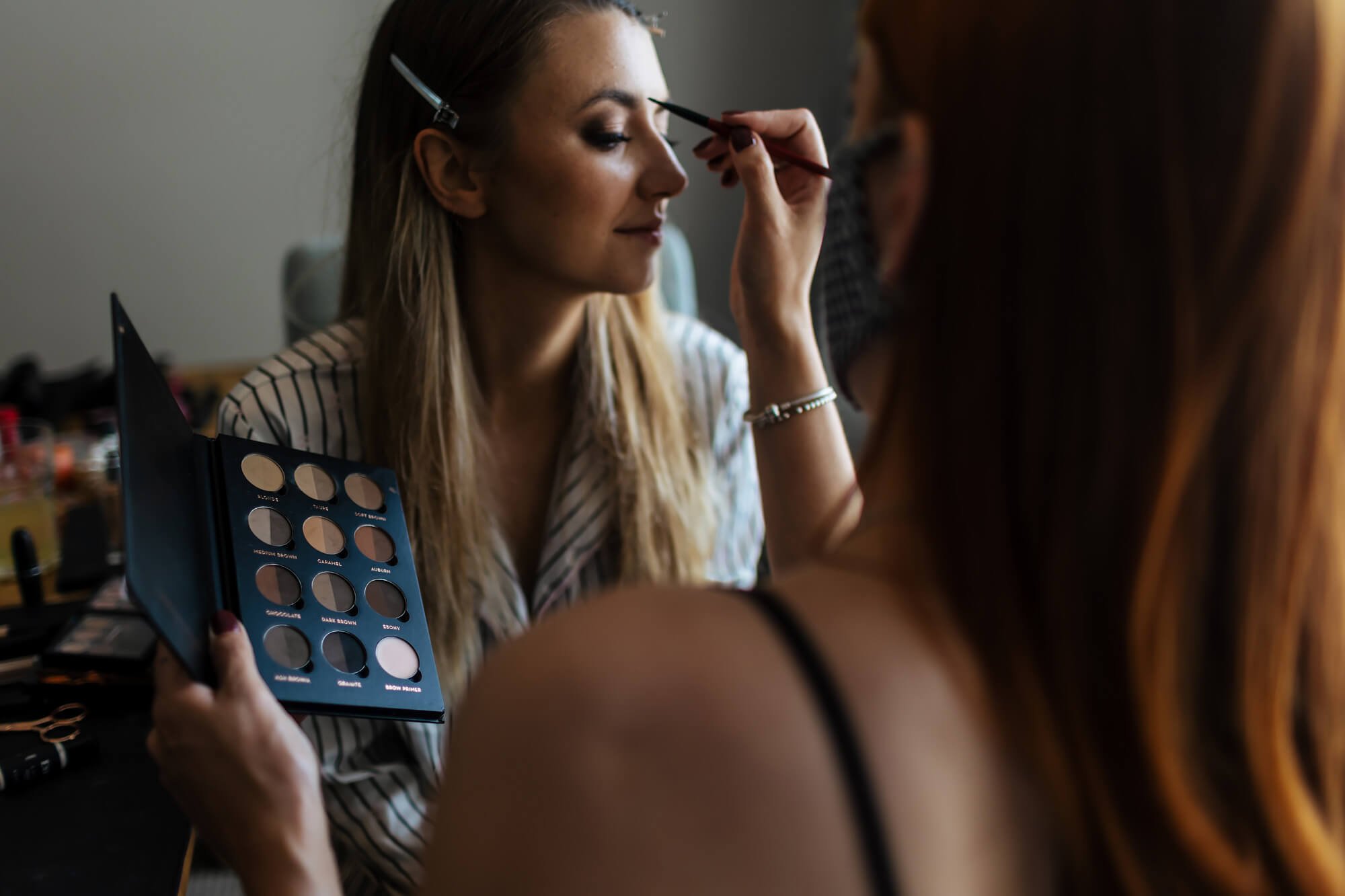 Makeup artist with the bride on her wedding morning