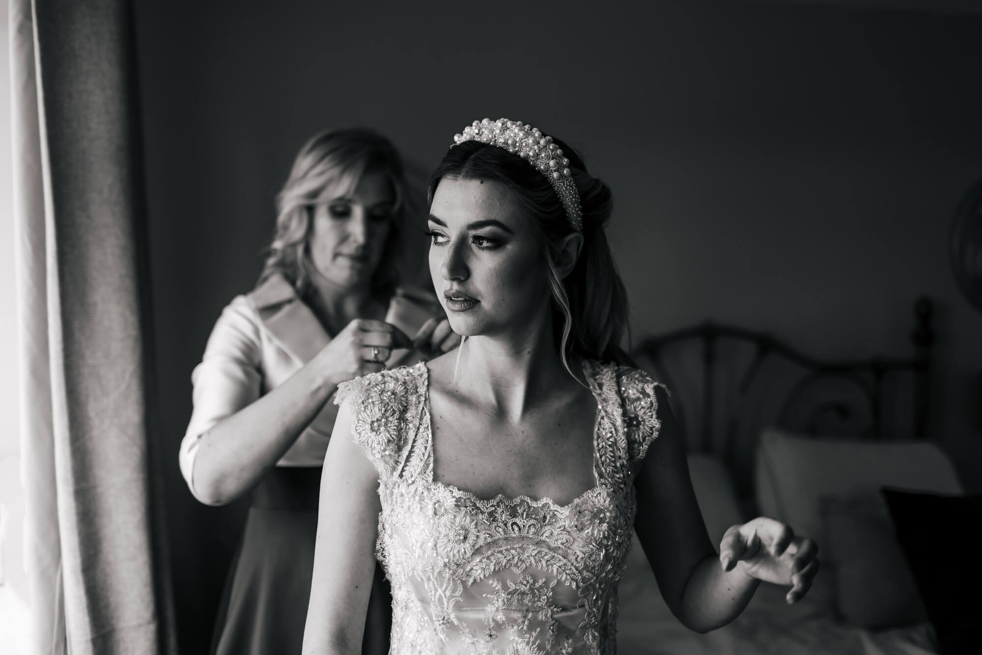 Bride getting into her dress for the wedding