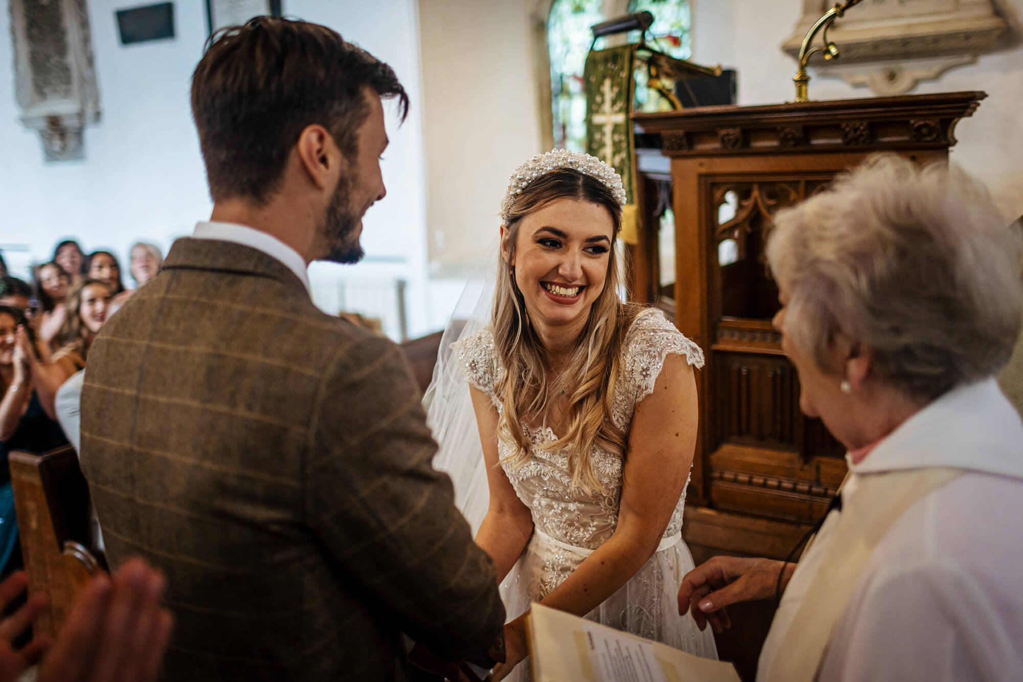 Bride laughing in the church at her wedding ceremony