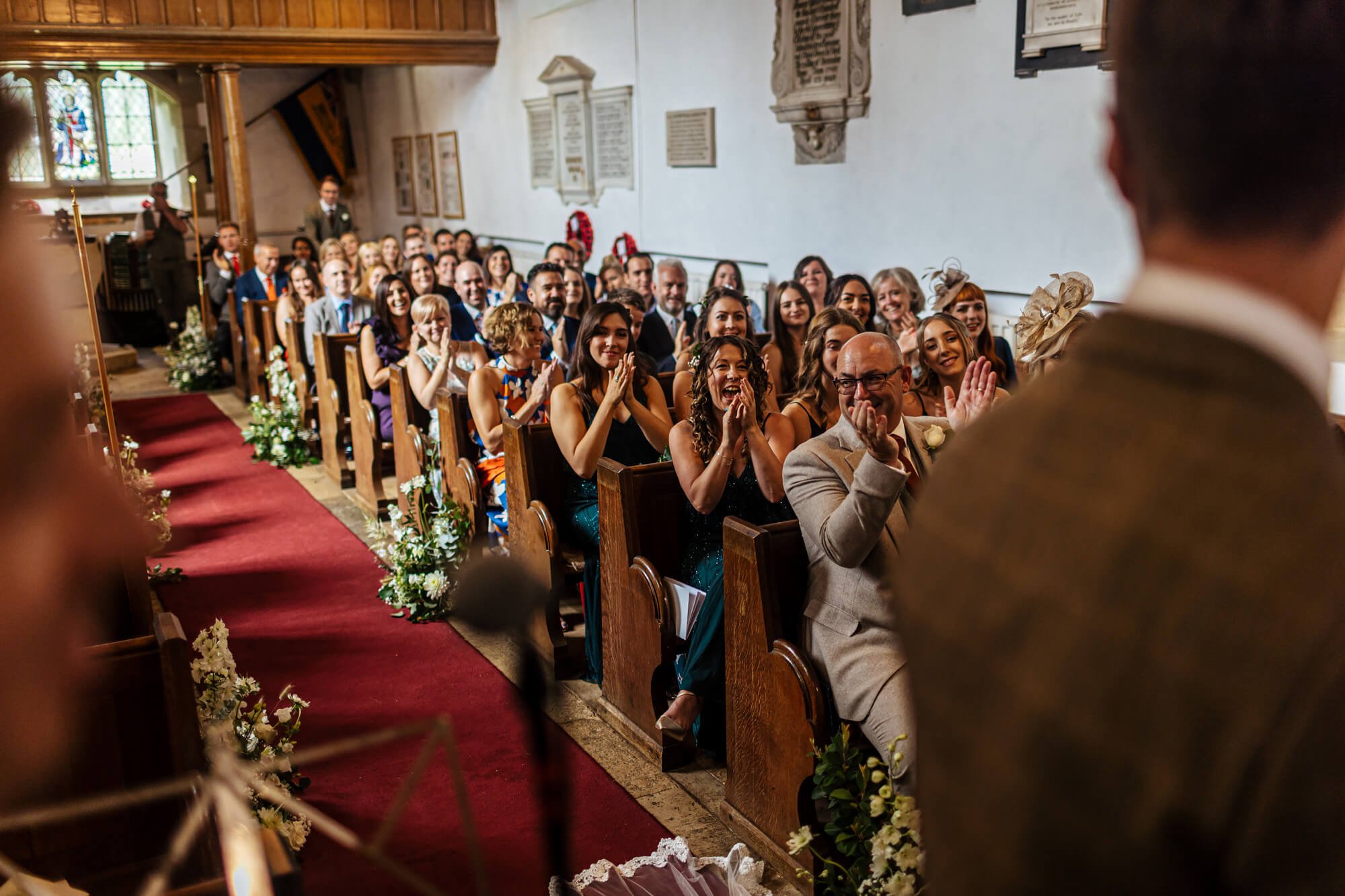 Wedding guests cheer at the ceremony