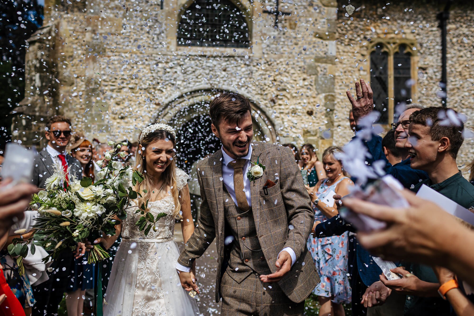 Confetti photo outside the church in the sunshine