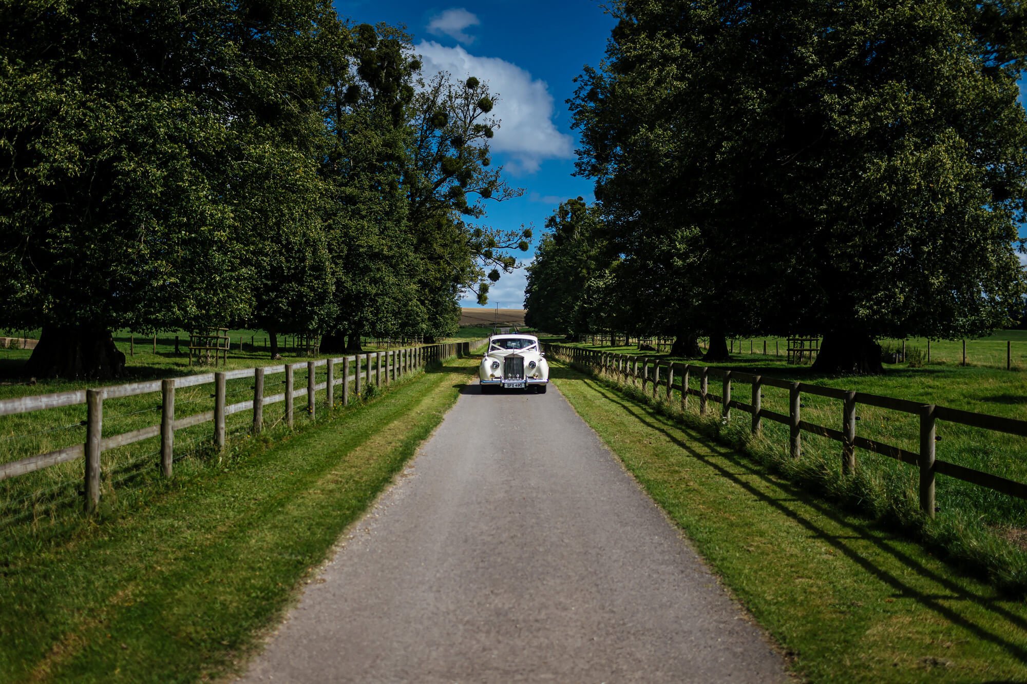 Vintage wedding car arrives at the reception venue