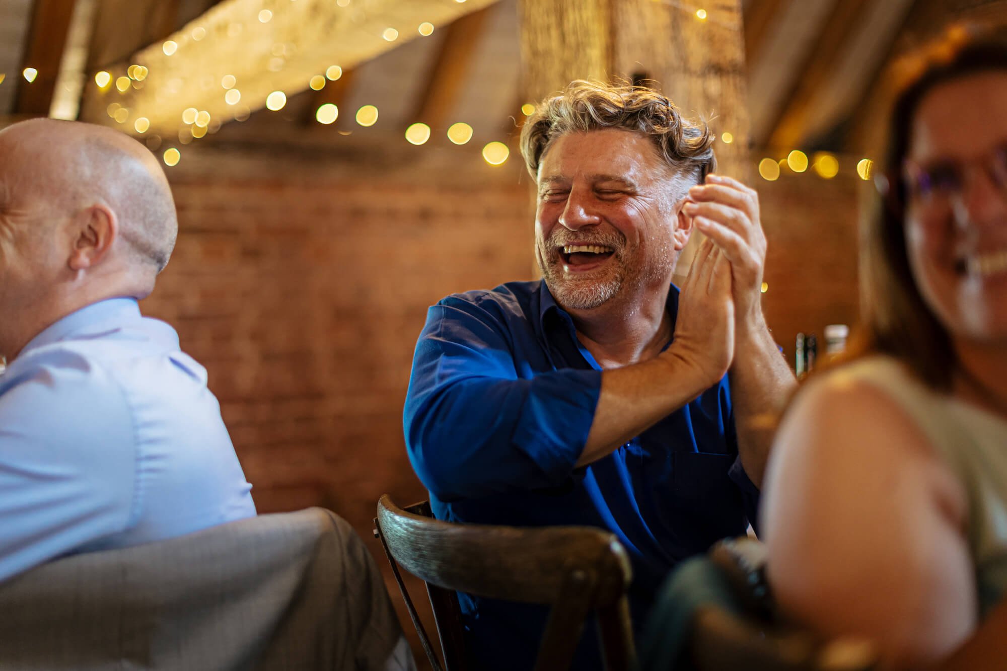 Guests laughing at a wedding