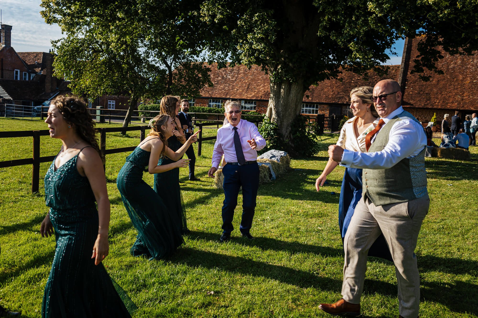 Wedding guests dancing in the evening sunshine