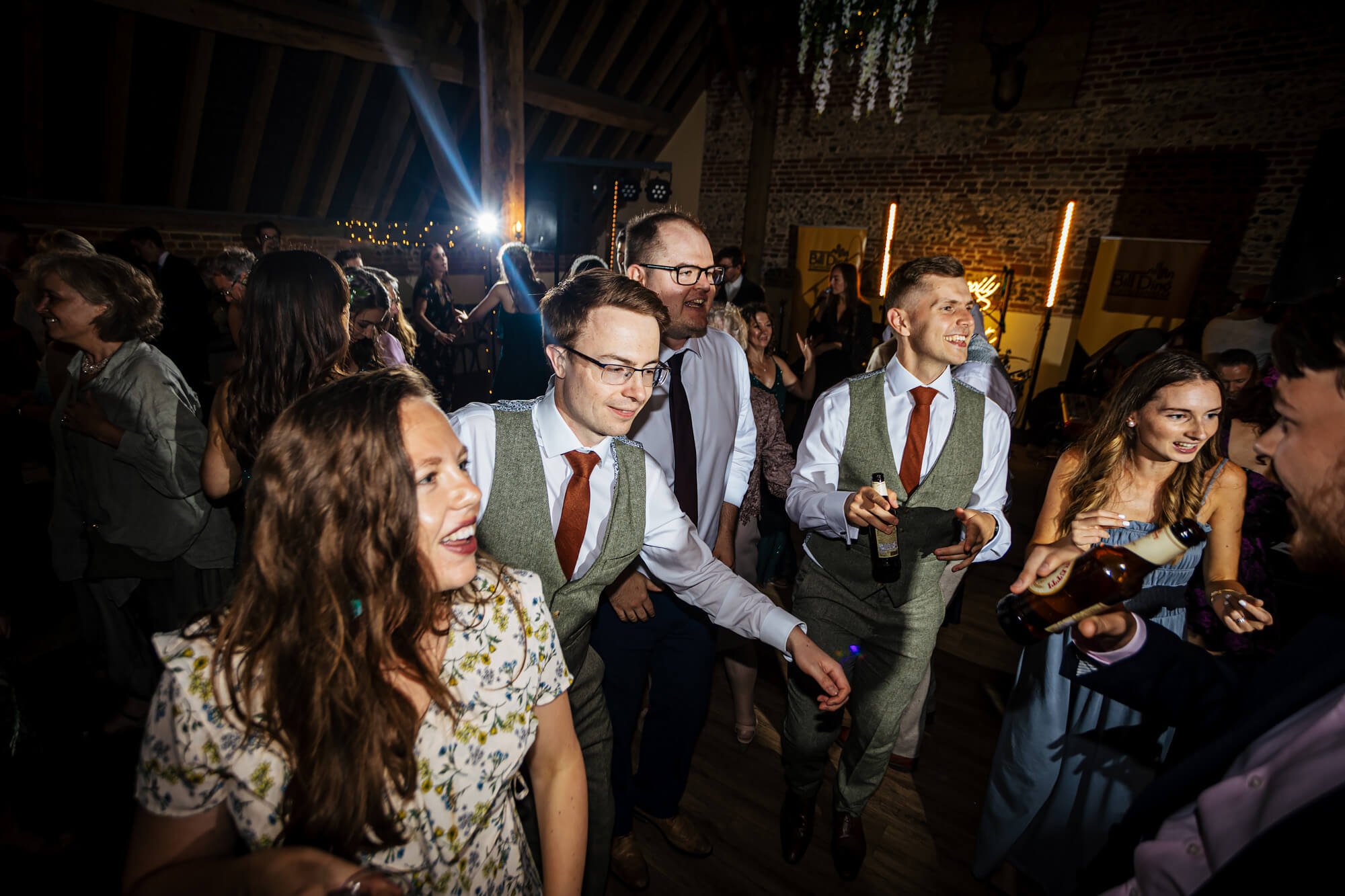 Wedding guests dancing and laughing
