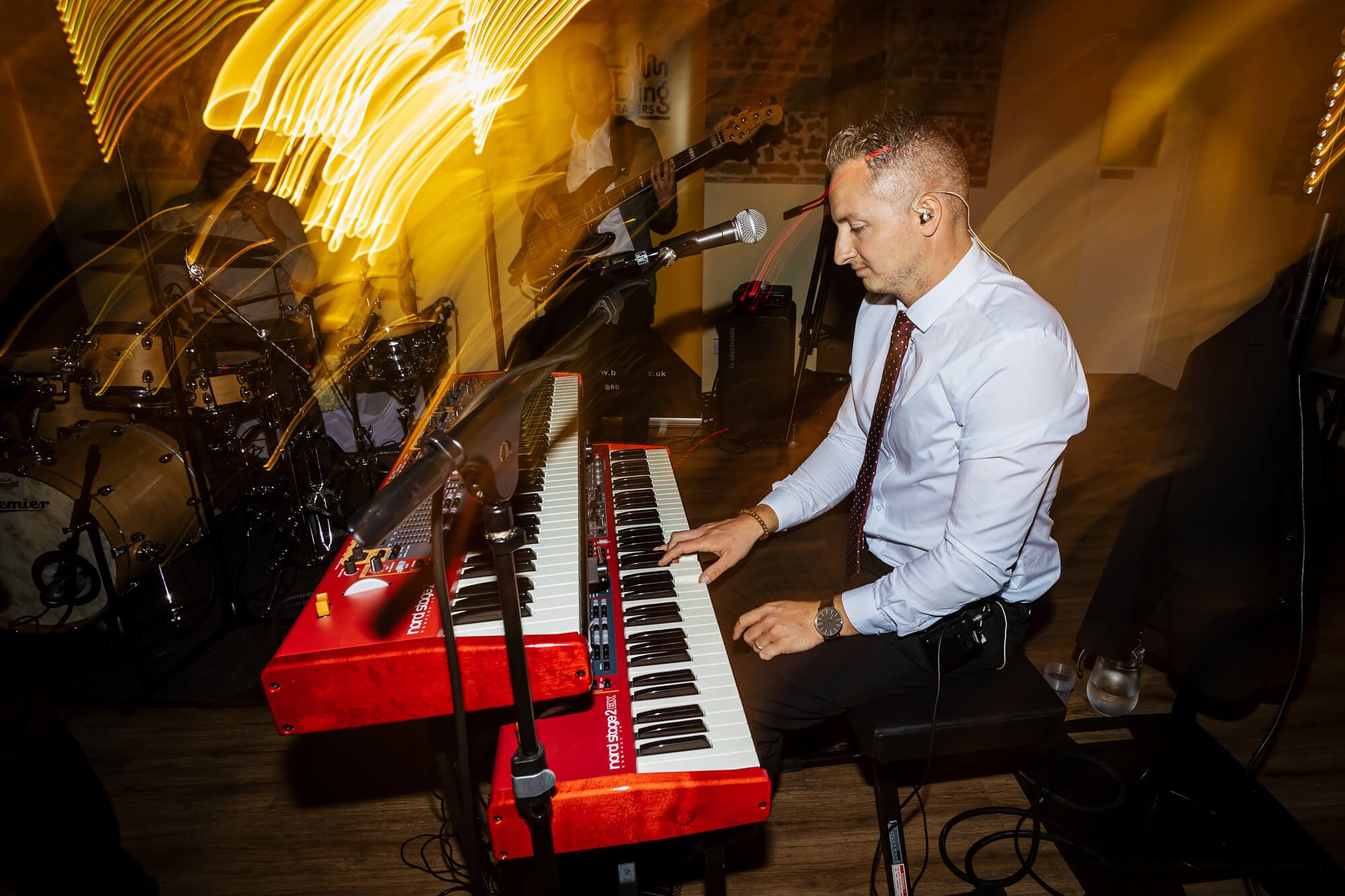 A musician playing at a Barford Park Barn wedding
