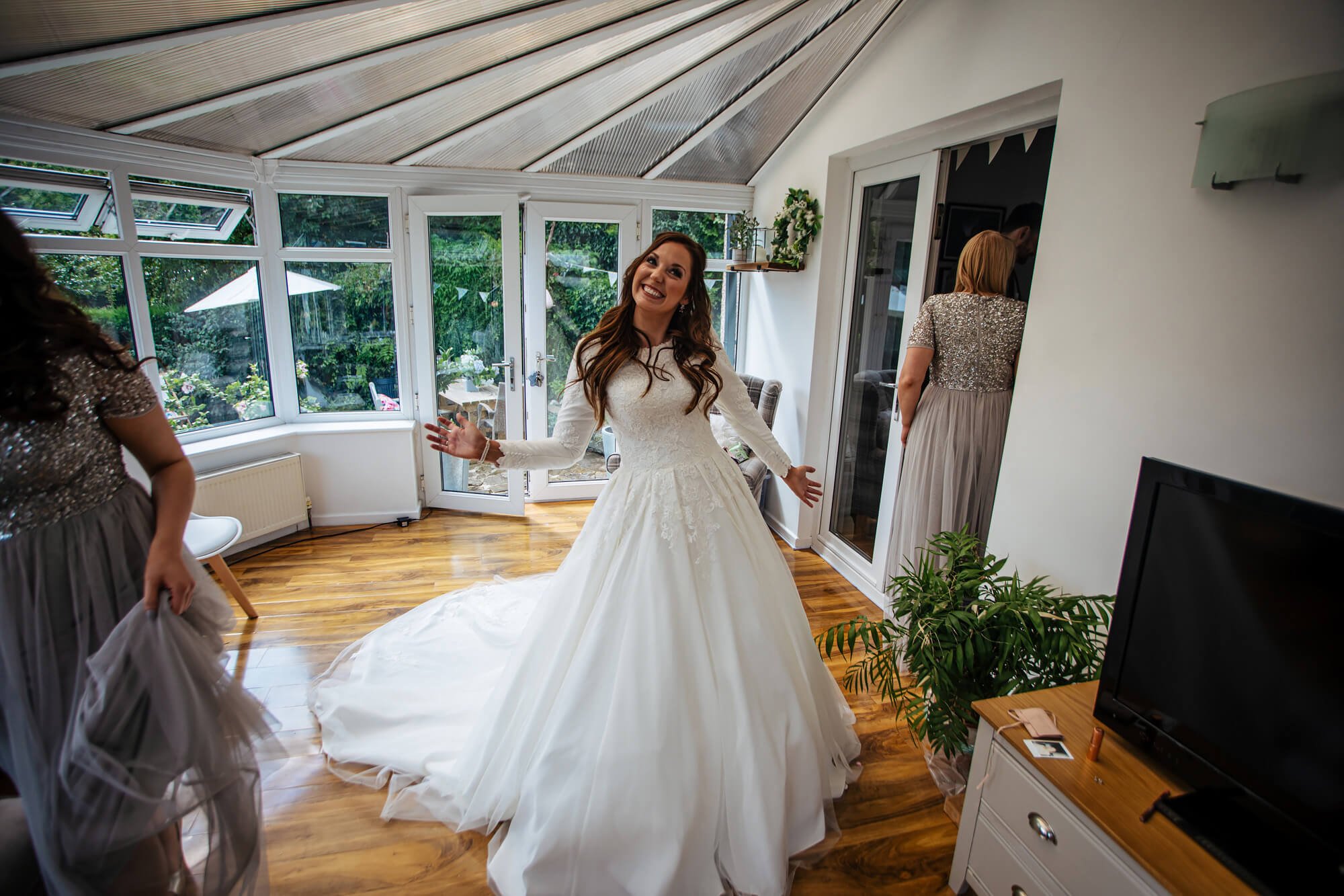 Bride poses in her wedding dress in the morning