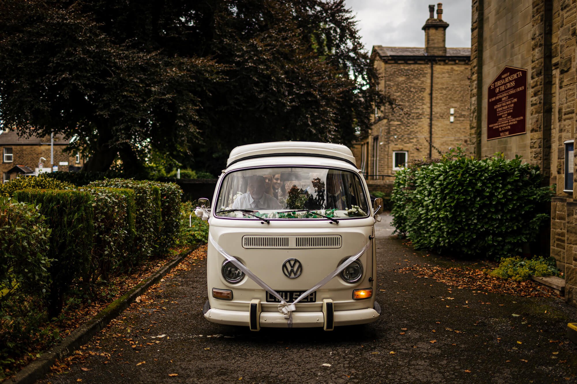 VW campervan arriving at a church wedding