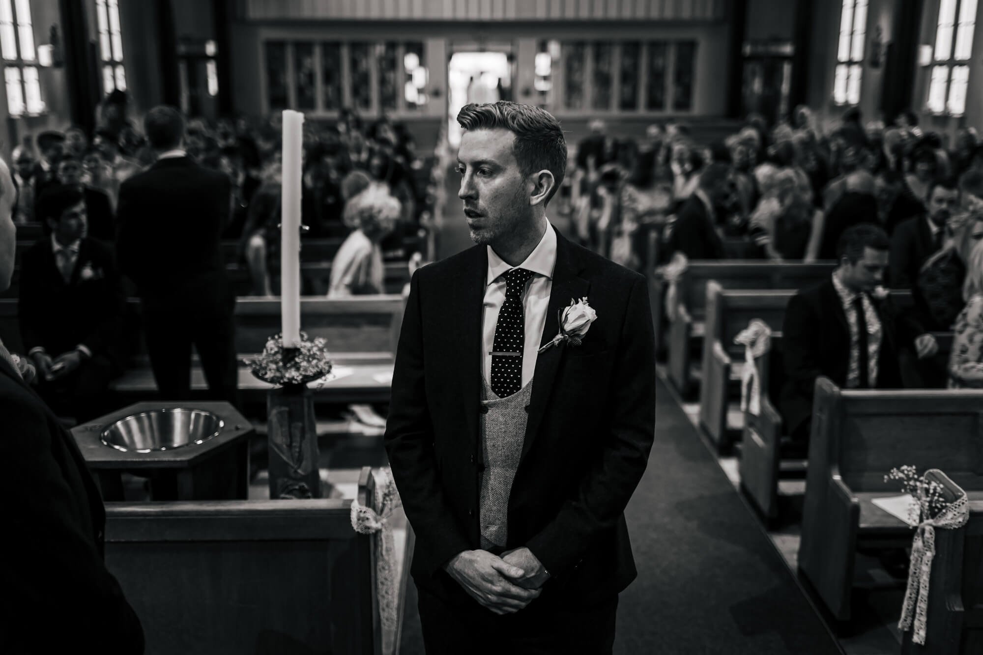 Groom nervously awaiting his bride at the church