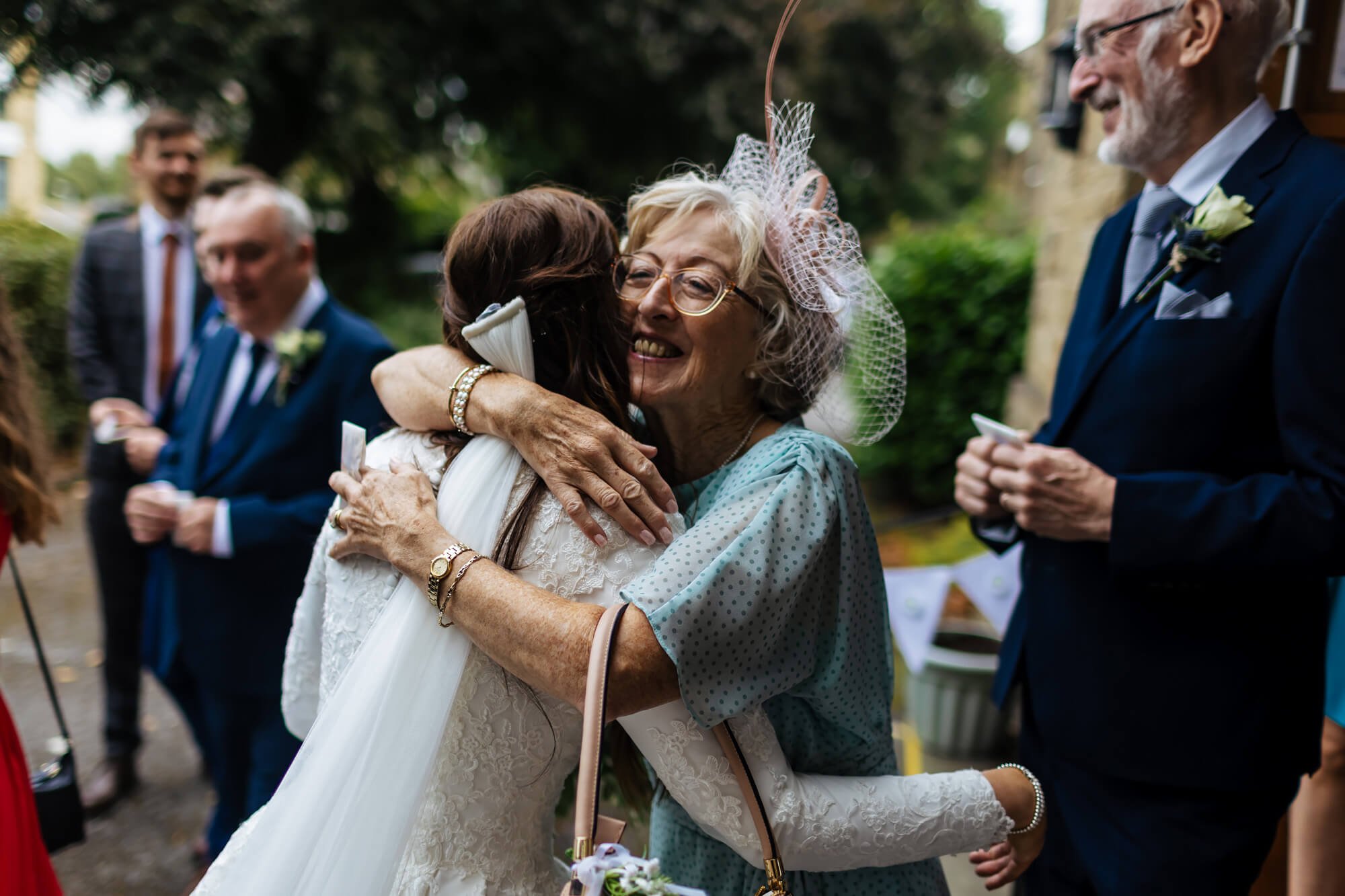 Bride and mum hug at the church wedding