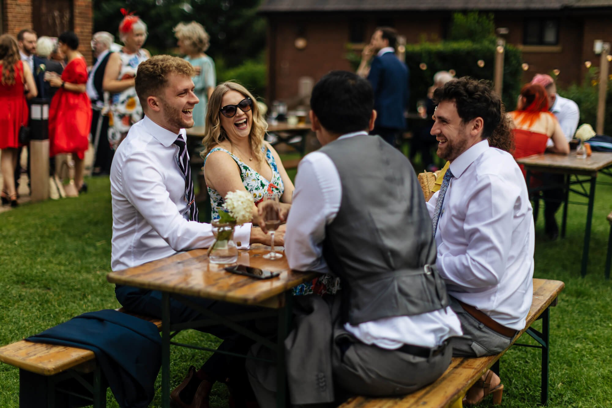 Wedding guests laughing in the Leeds sunshine