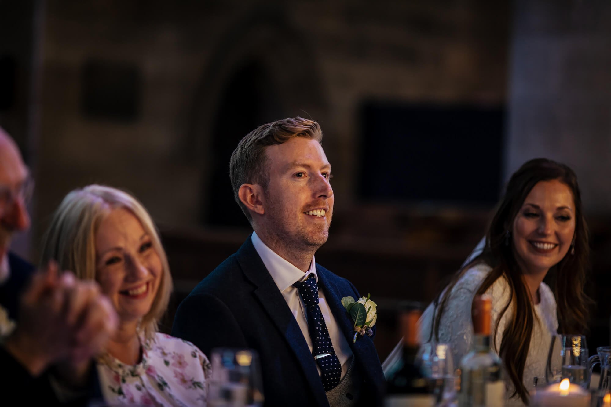 Groom laughing at the wedding speeches