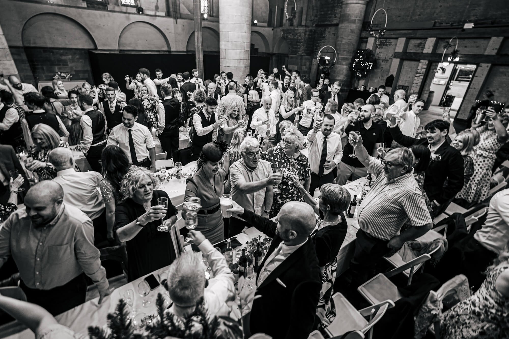 Wedding guests toast the speeches at Left Bank Leeds