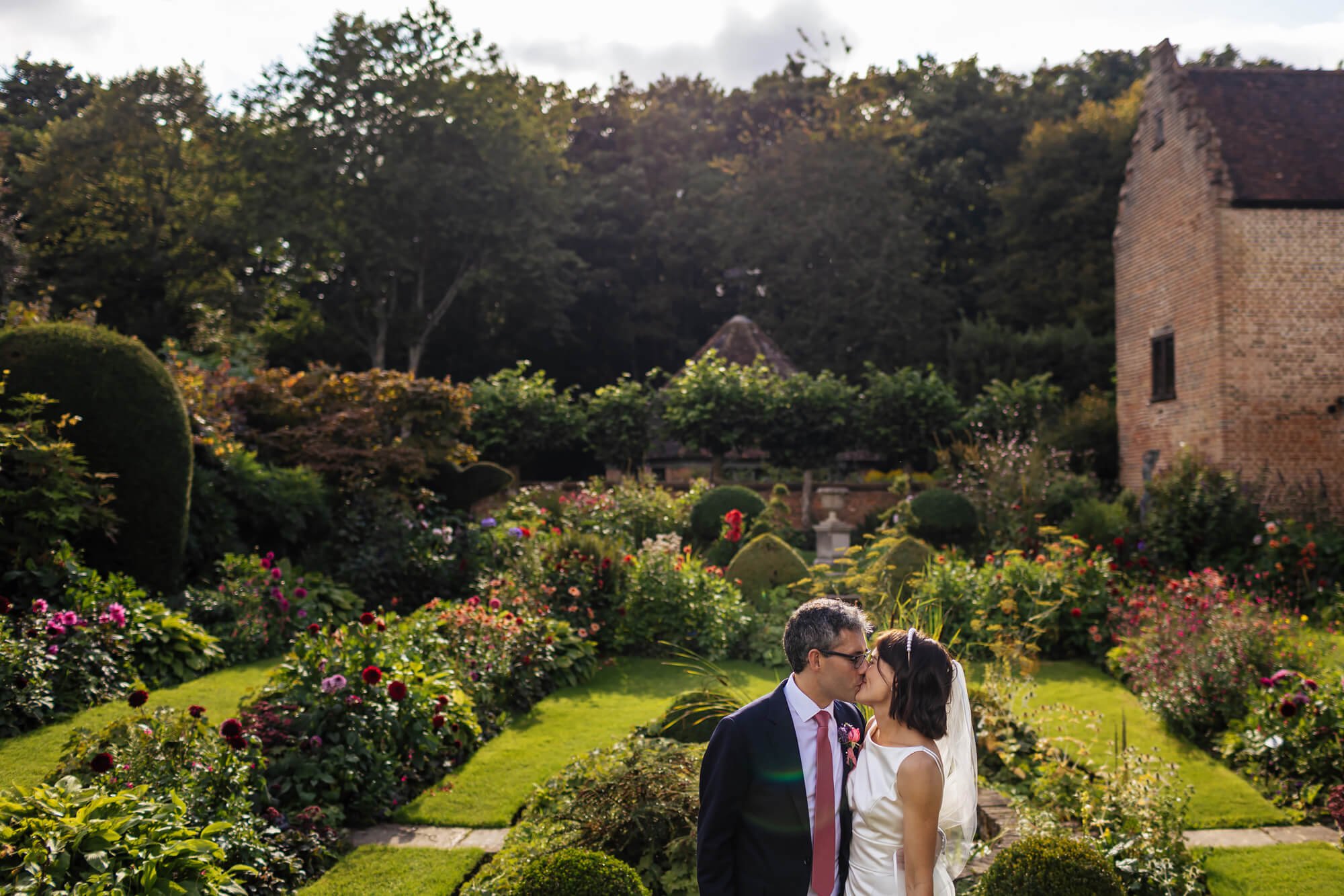 Bride and groom share a kiss at Chenies Manor