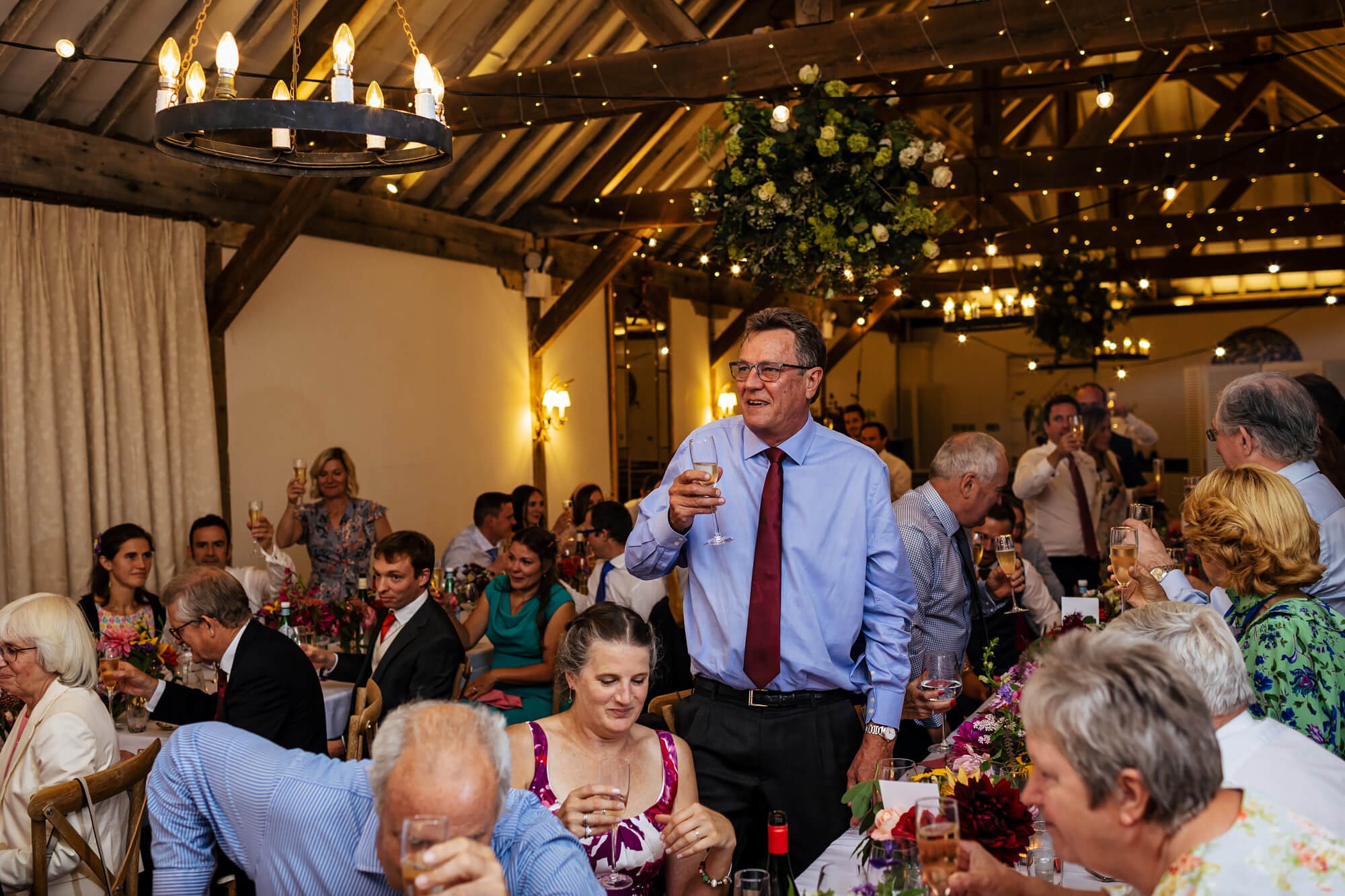 Wedding guests cheer during the speeches