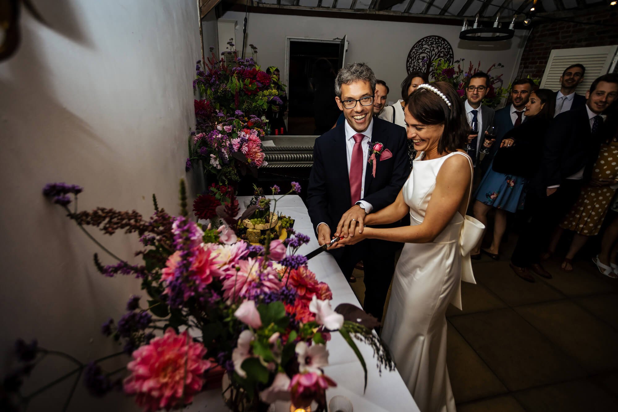 Cutting the cake at a Chenies Manor wedding