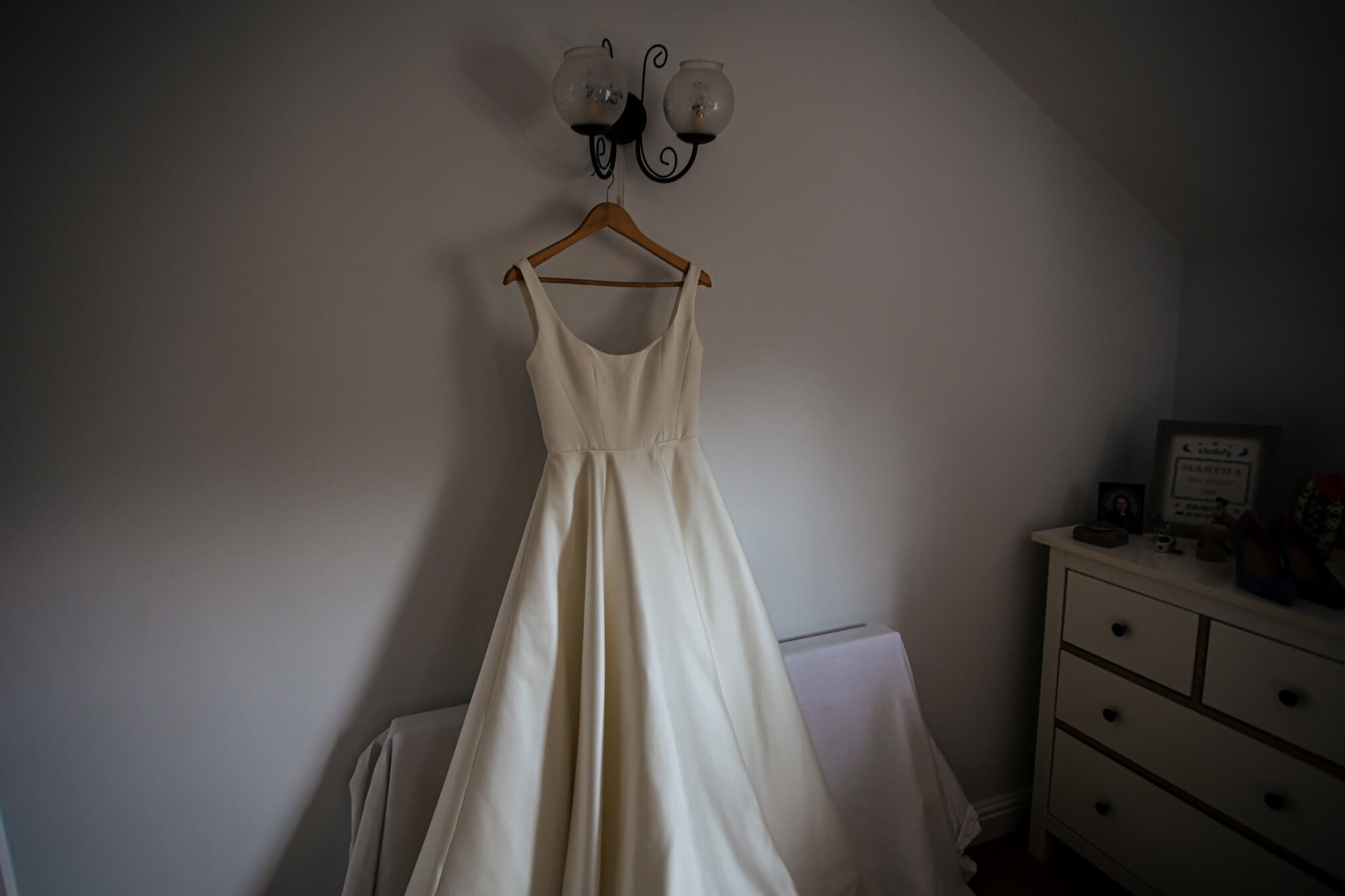 Wedding dress hanging up in the morning