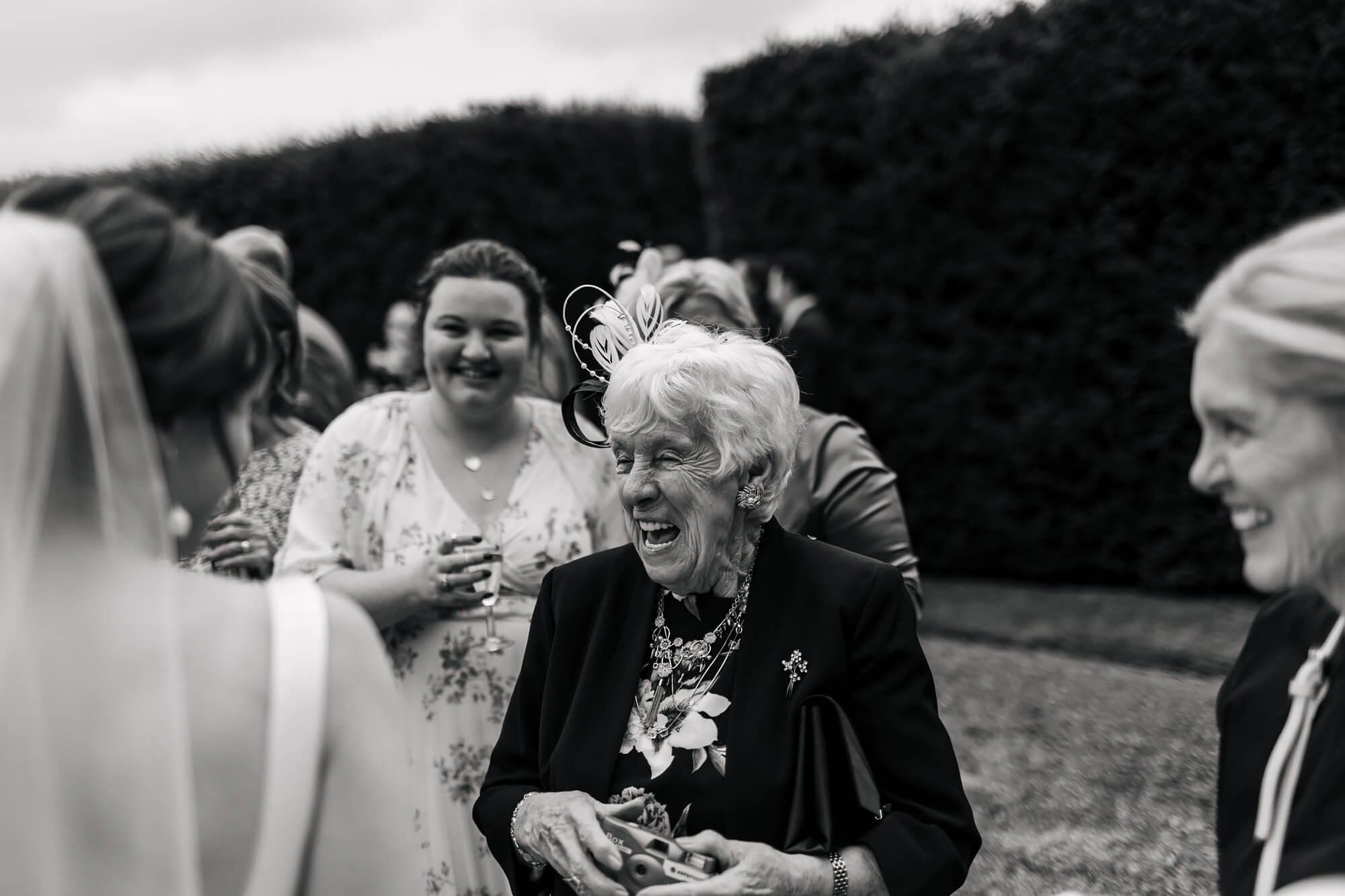 Grandparents laughing at a wedding