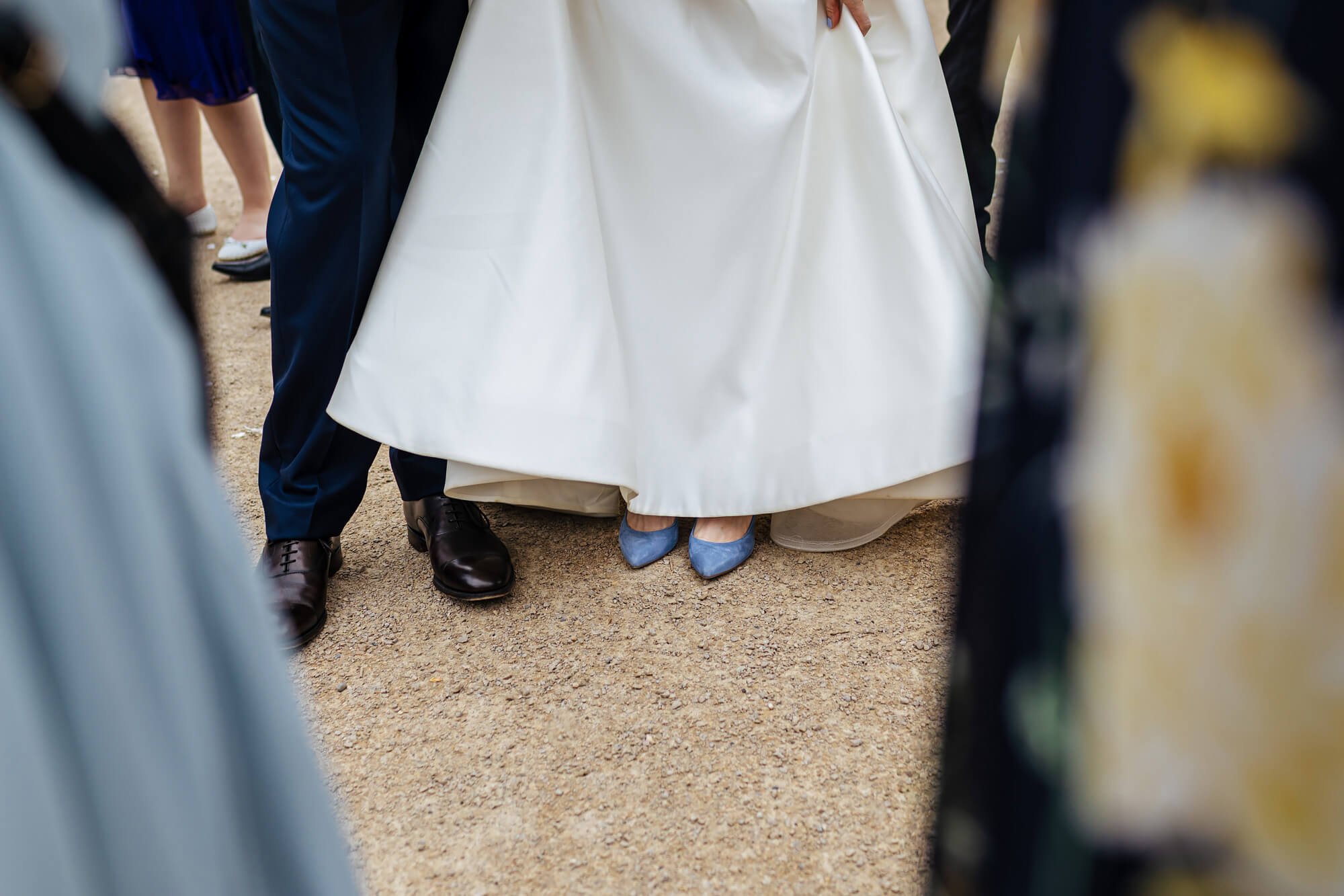 Bride shows off her blue wedding shoes