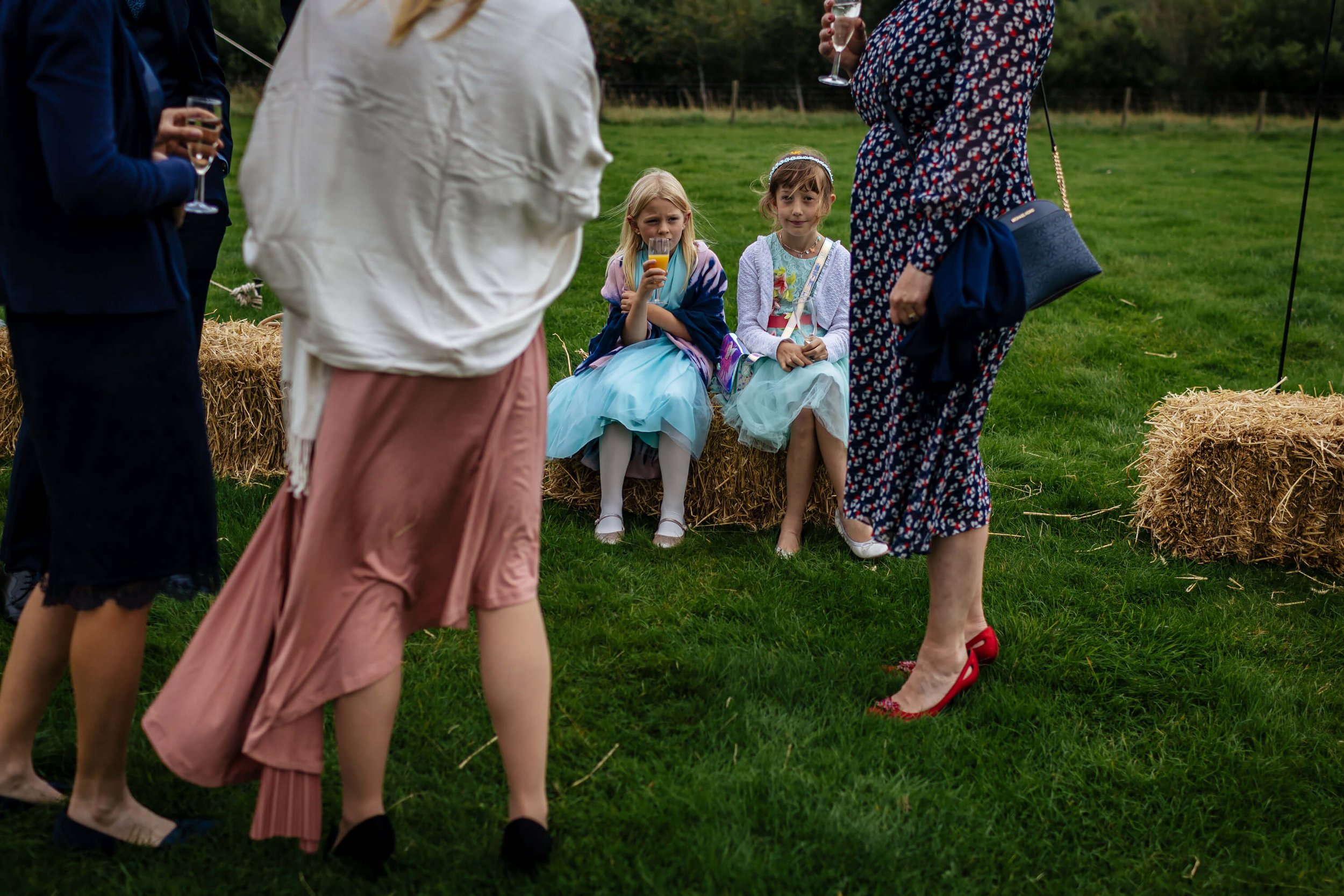 Young girls drinking orange juice at a Yorkshire wedding