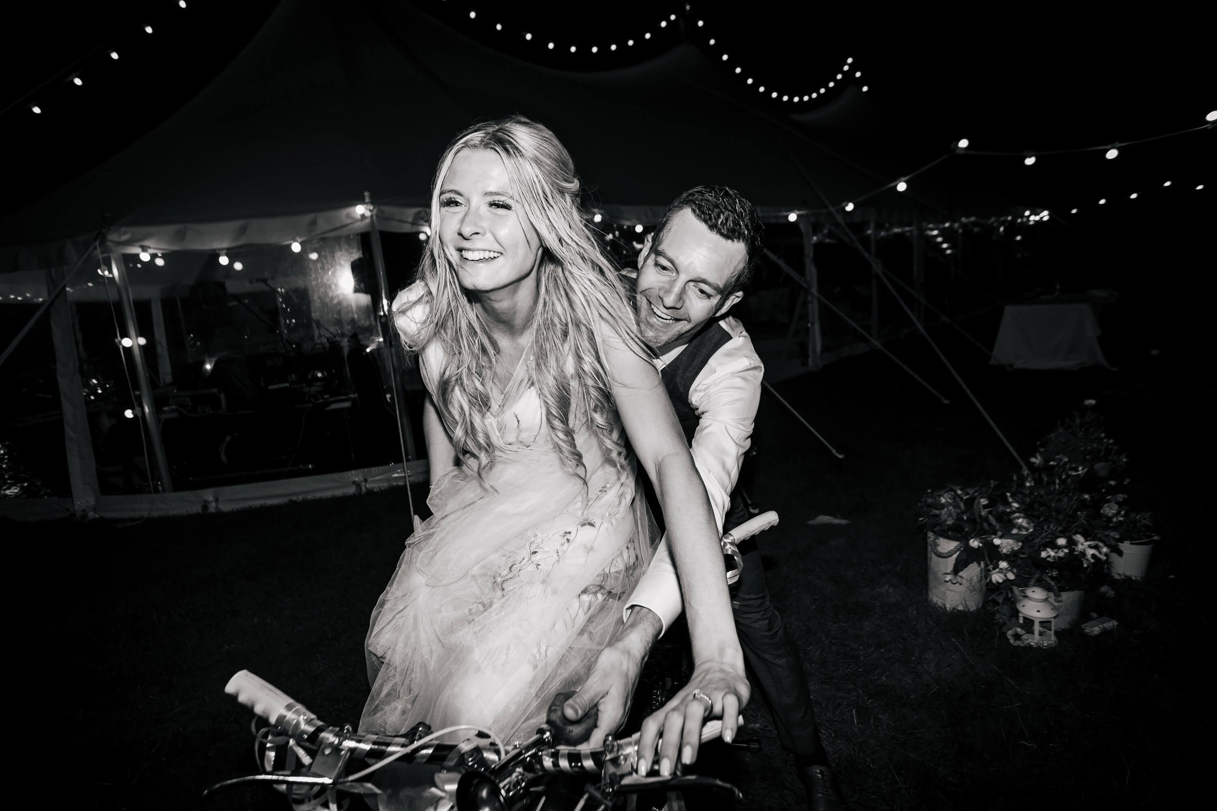 Bride and groom on a tandem at their wedding