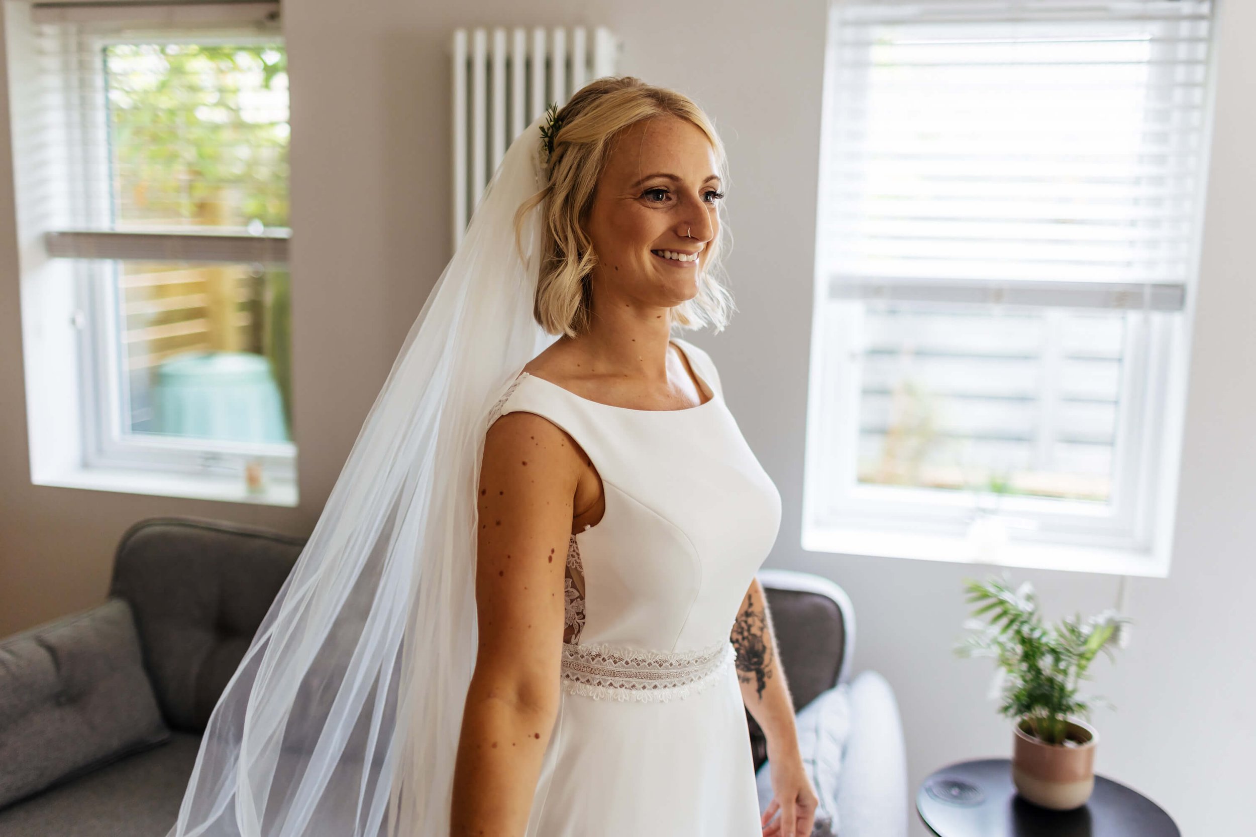 Bride smiling on her wedding morning in the dress