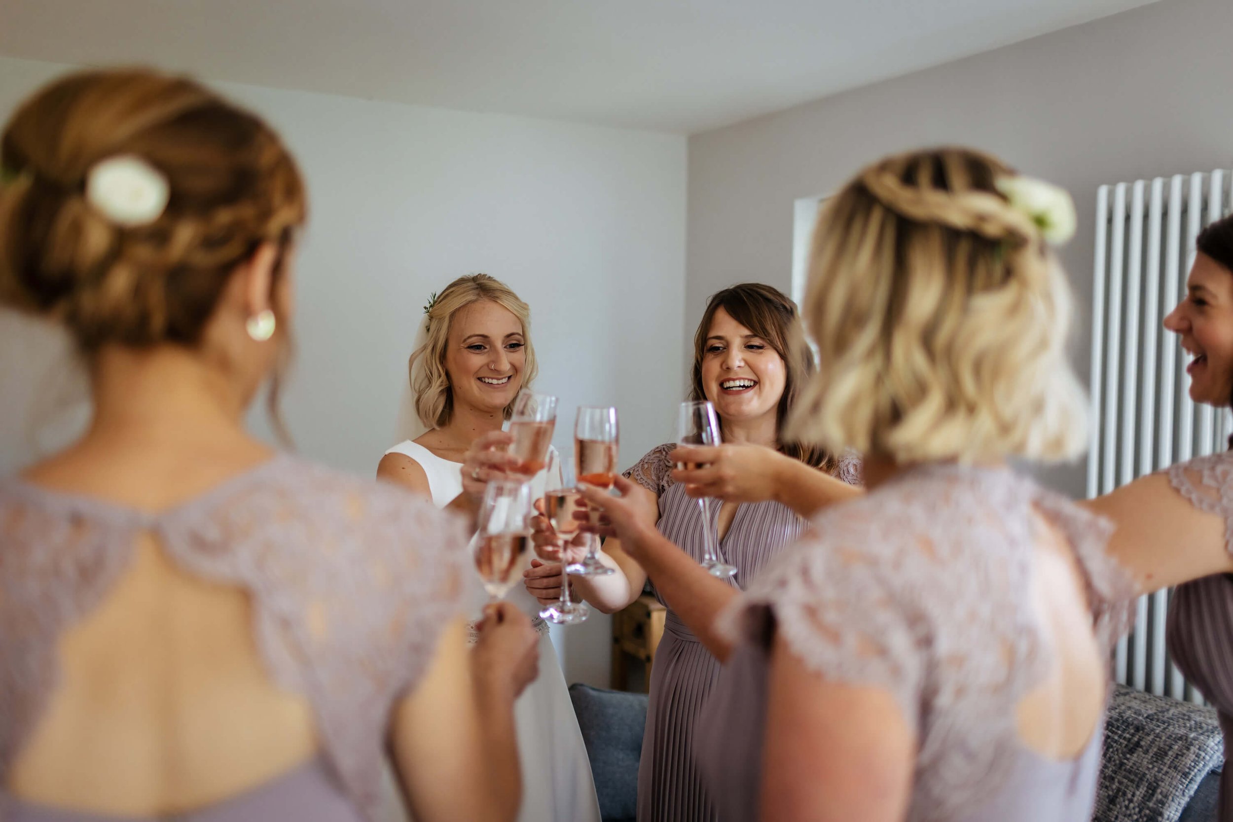 Bridesmaids with glasses of bubbly before the wedding