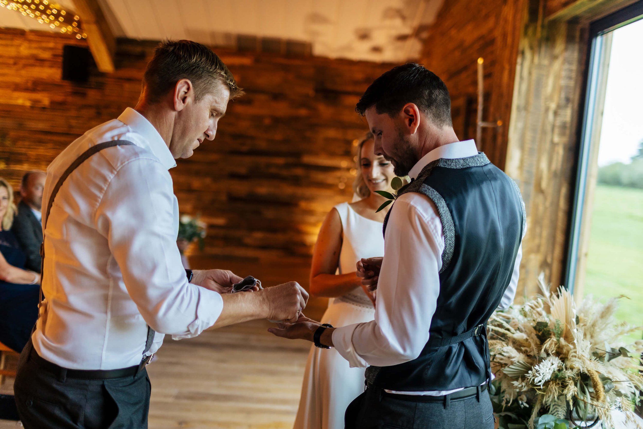 Best man passes the rings to the groom at the wedding ceremony
