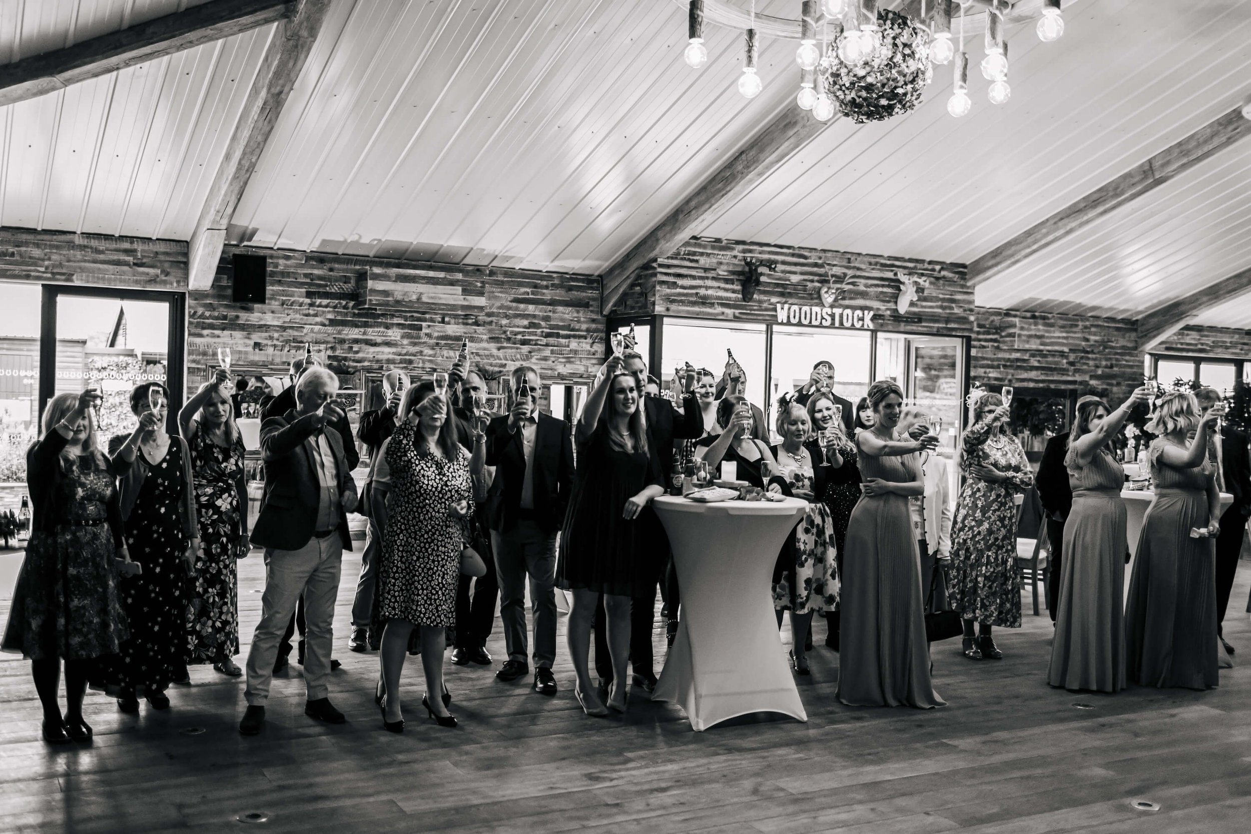 Wedding guests toast the speeches with champagne