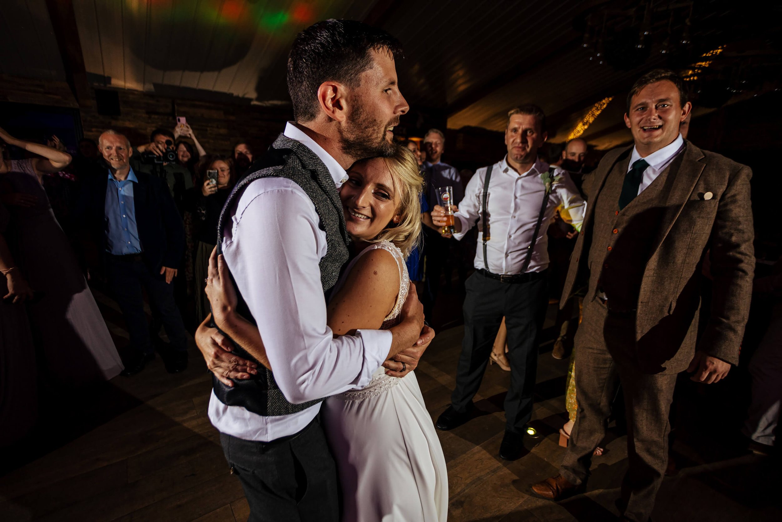 Bride and groom share a hug on the dance floor