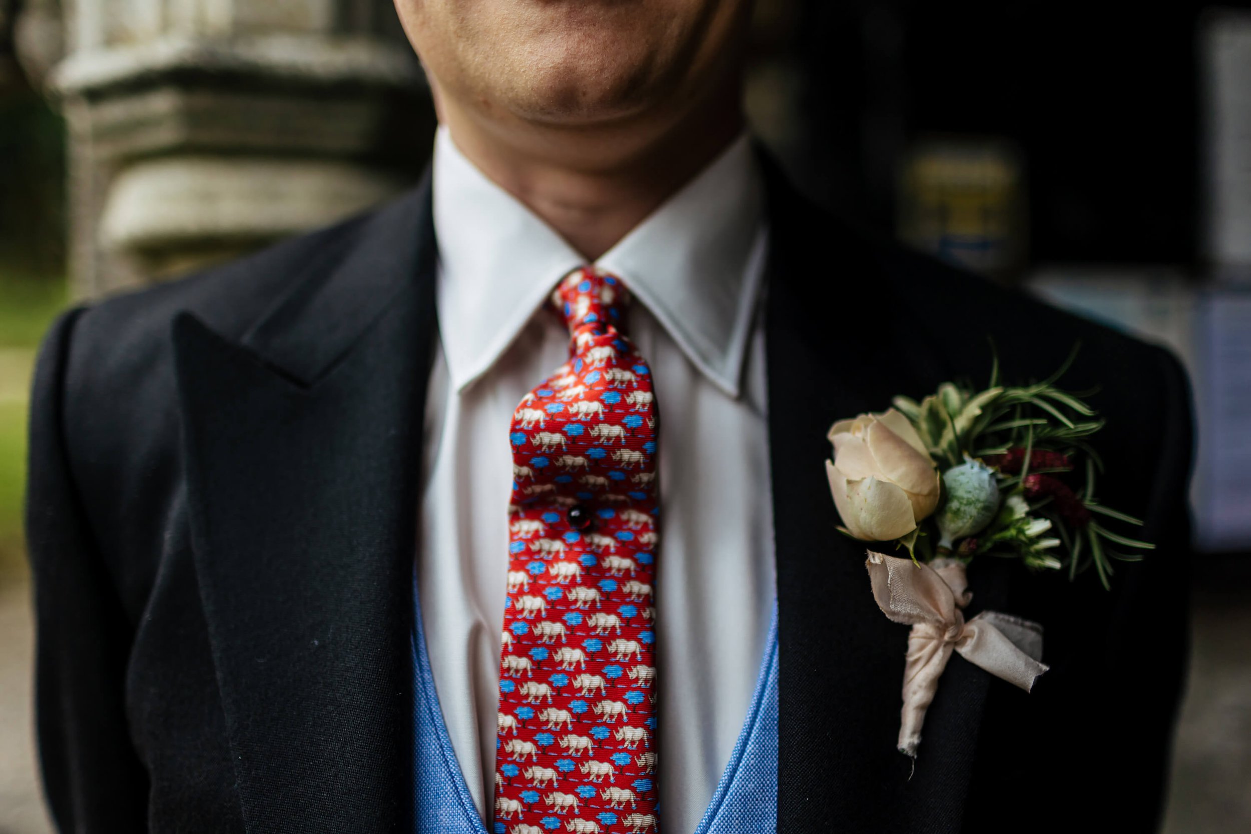 A close up of the groom's tie and buttonhole