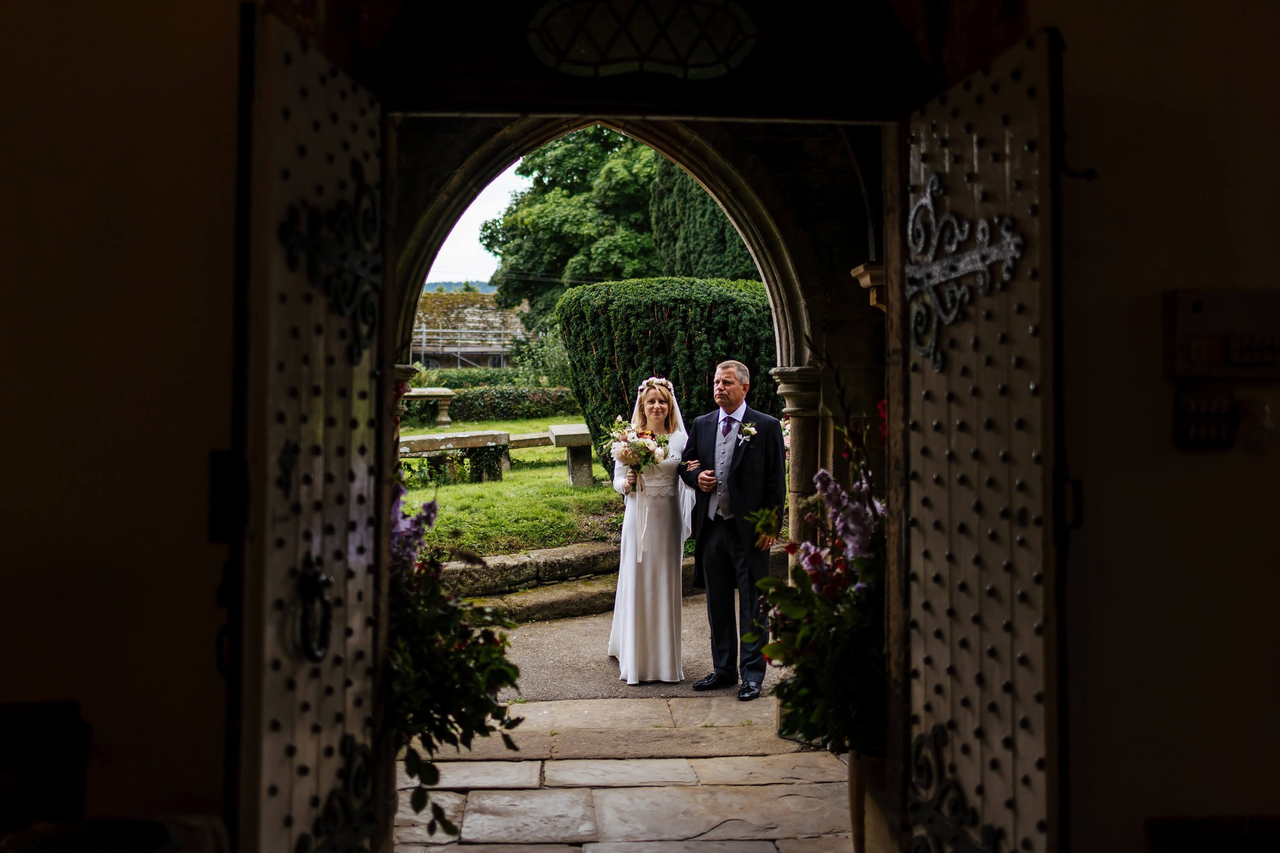 Bride and dad nervously wait outside the church in Burnsall