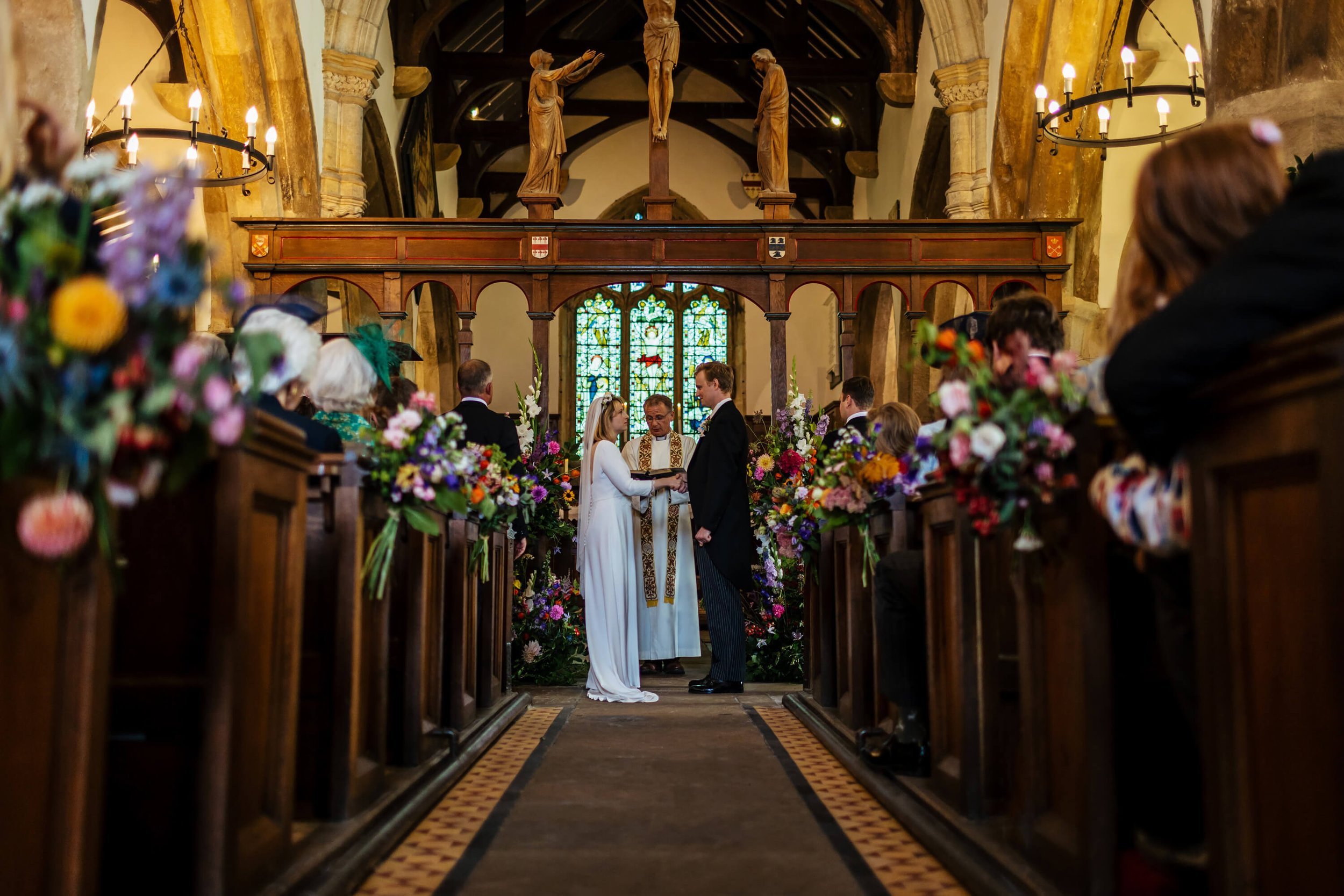 Bride and groom hold hands during their wedding ceremony in Yorkshire