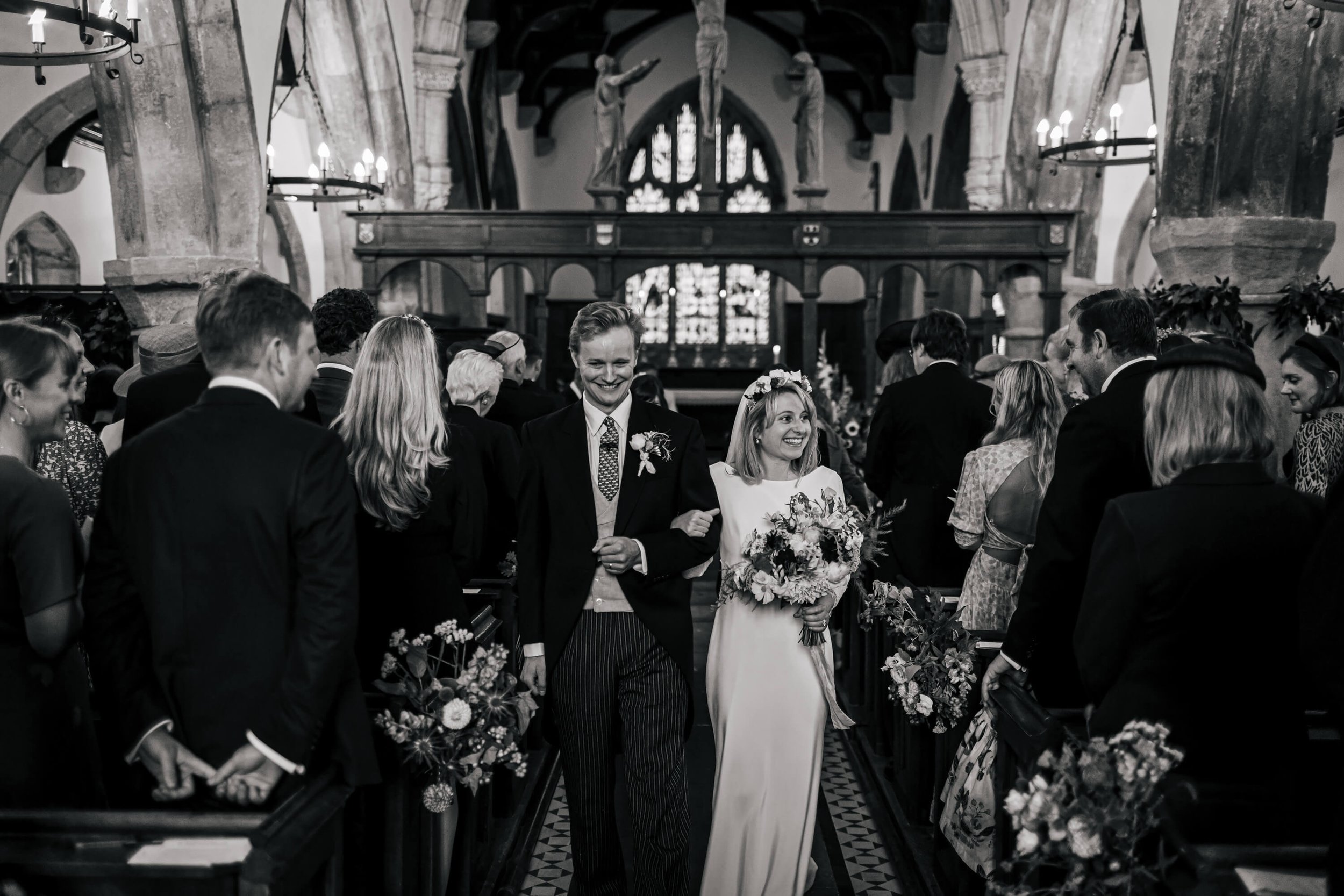 Bride and groom walking down the aisle at St Wilfrid's church in Burnsall