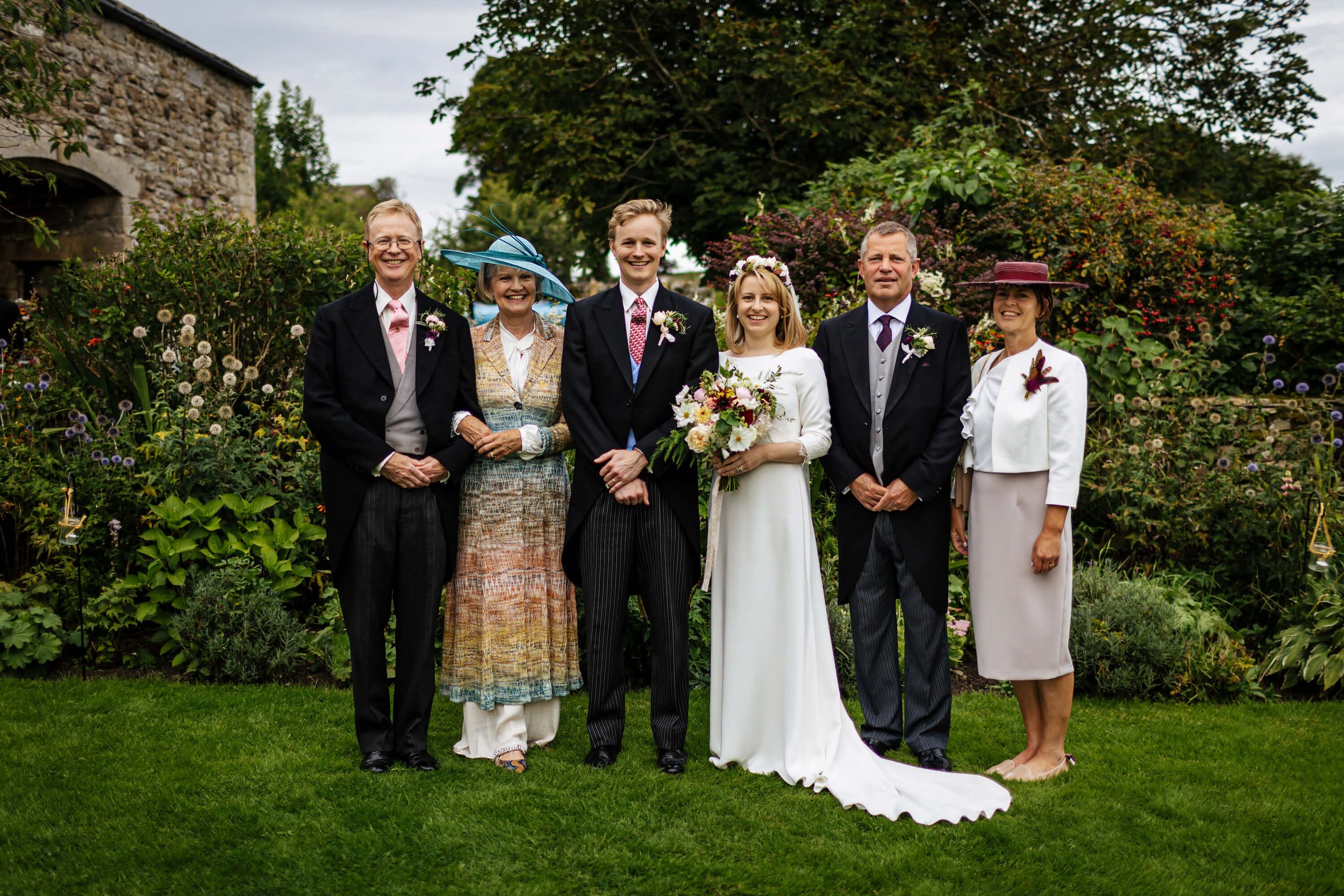 Bride and groom with both sets of parents at the wedding