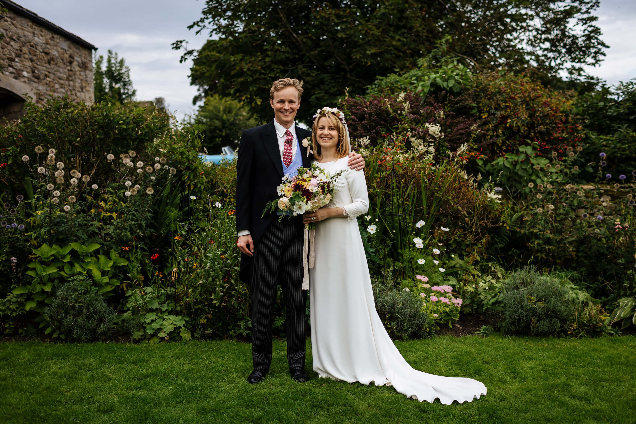 Bride and groom in amongst the flowers in Yorkshire