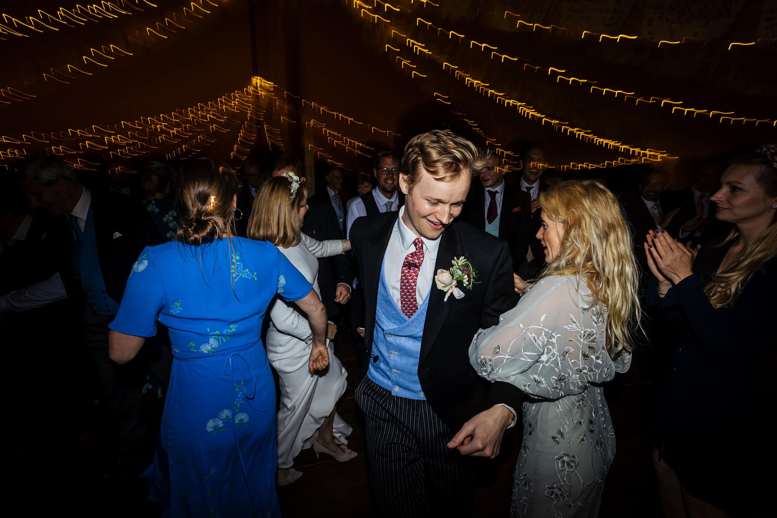 Groom dancing with guests at his wedding reception