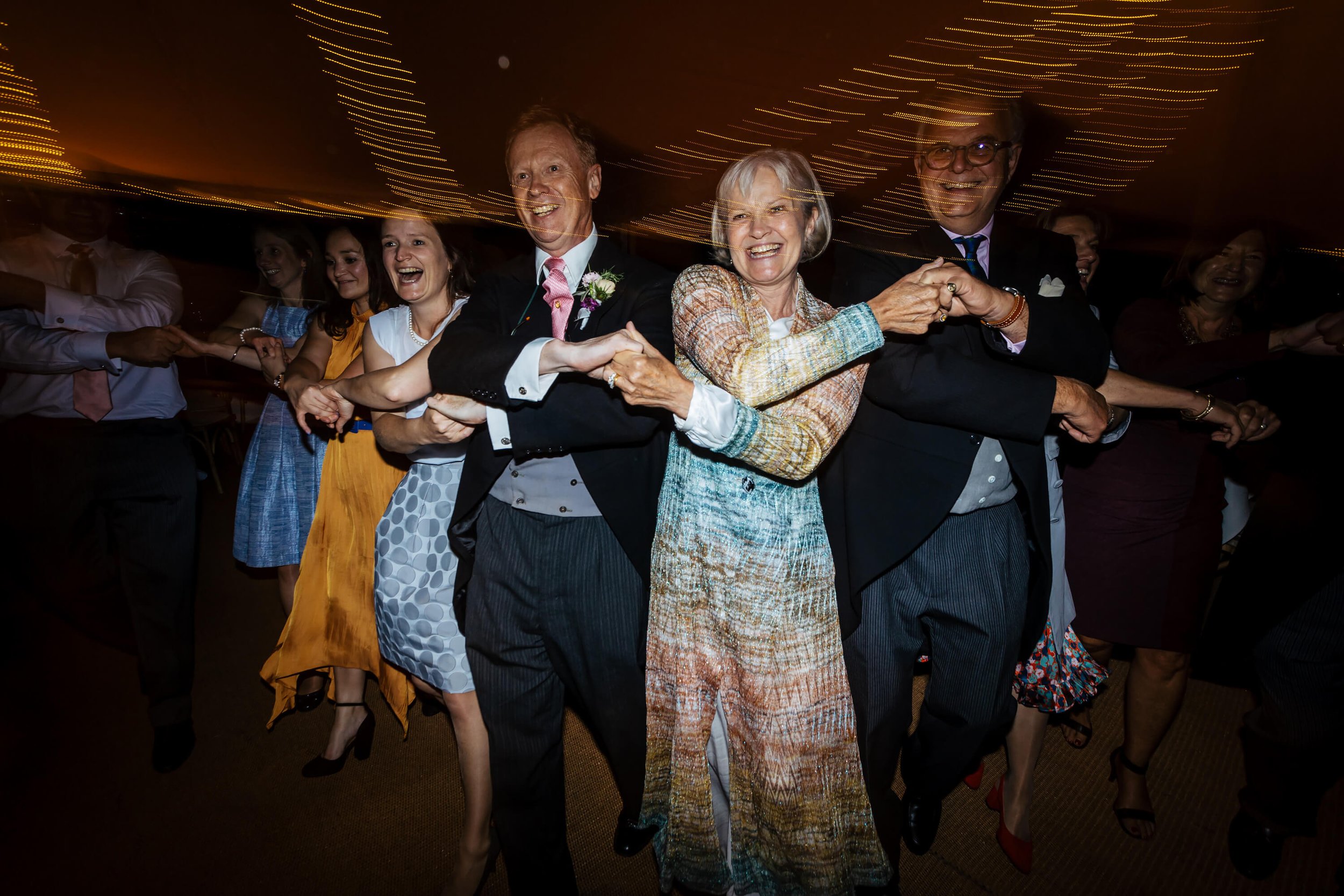 Linking arms on the dance floor at a Burnsall wedding