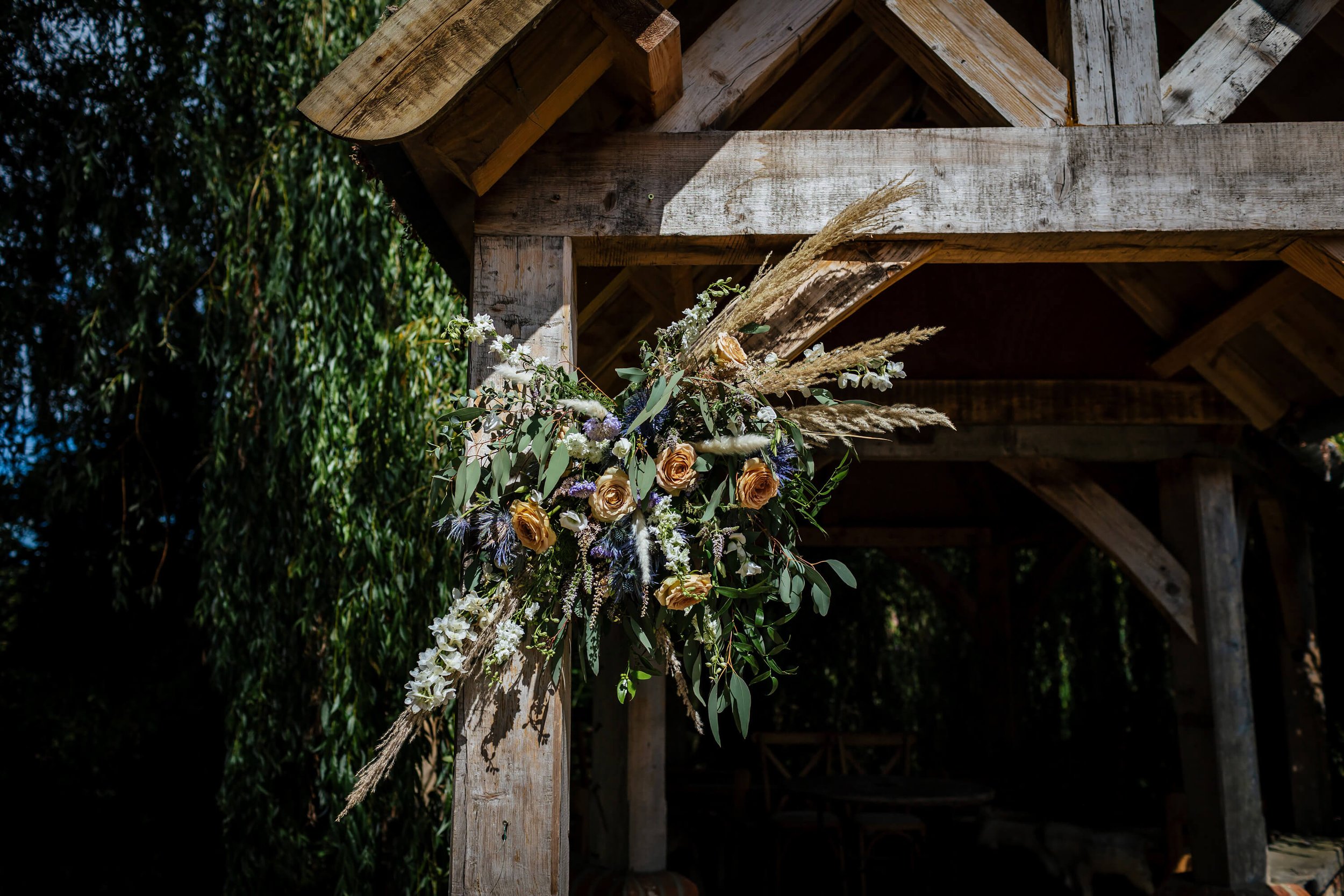 A beautiful flower bouquet attached to the ceremony structure