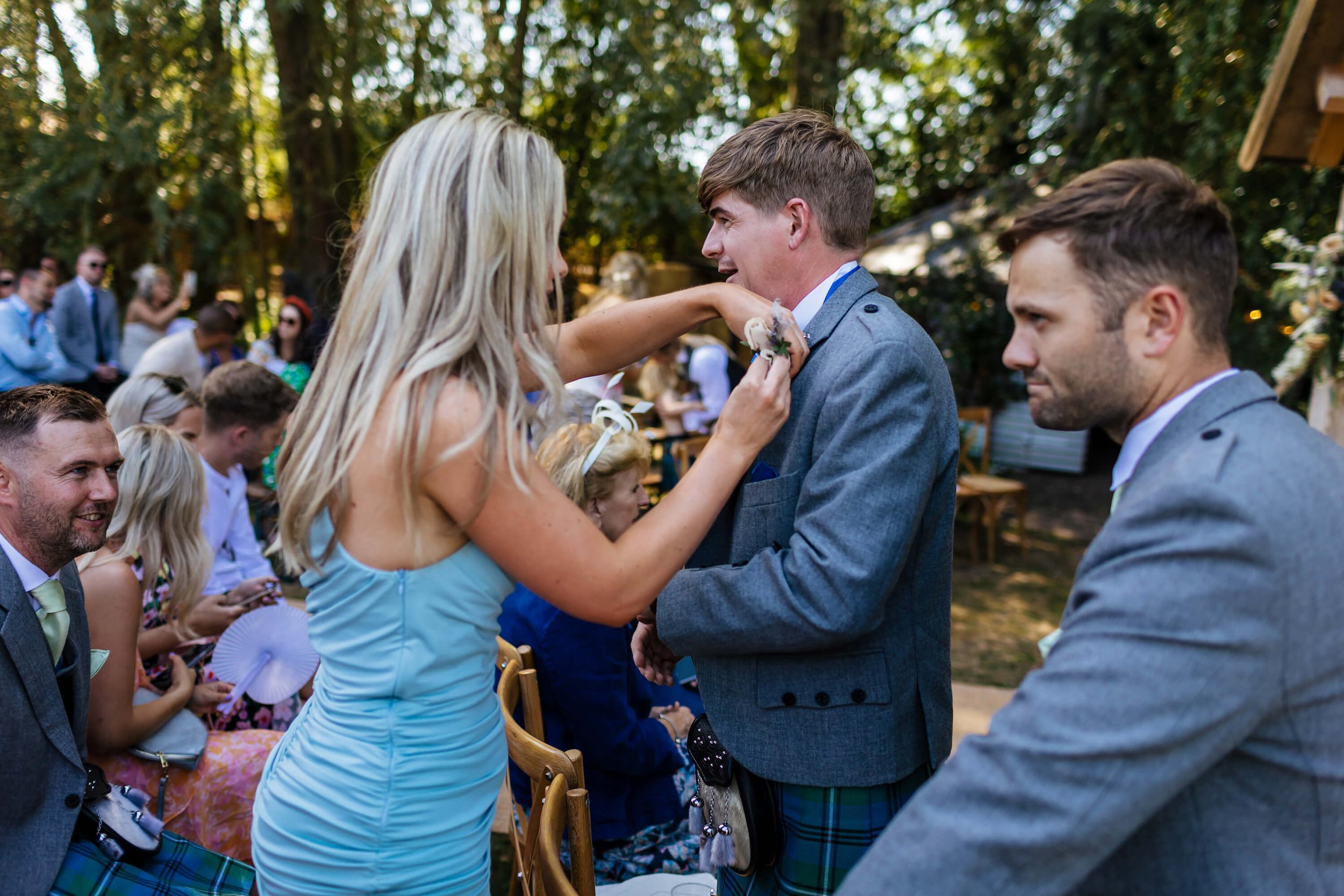 Groom having his buttonhole attached before the ceremony